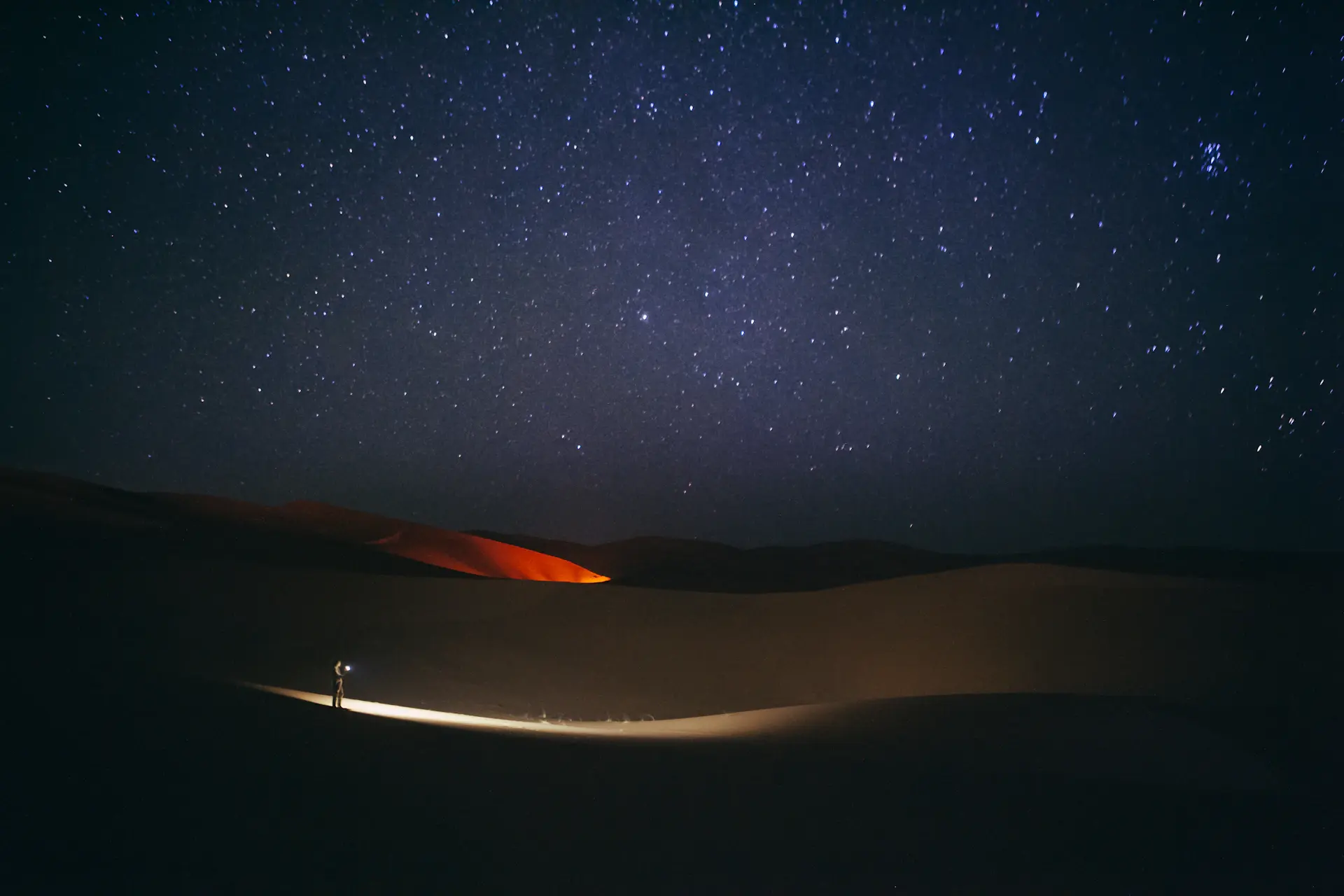 Soft afternoon shadows falling across rolling sand dunes