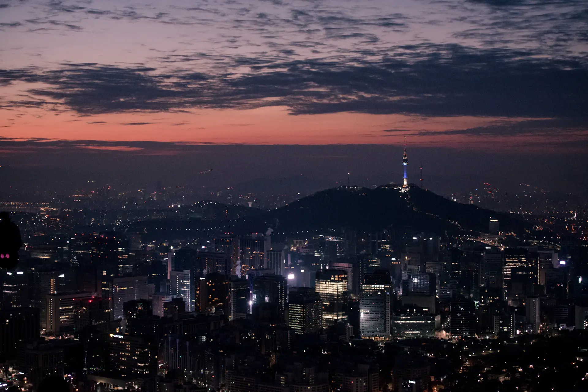 Cinematic view of Seoul skyline with a historic palace at golden hour