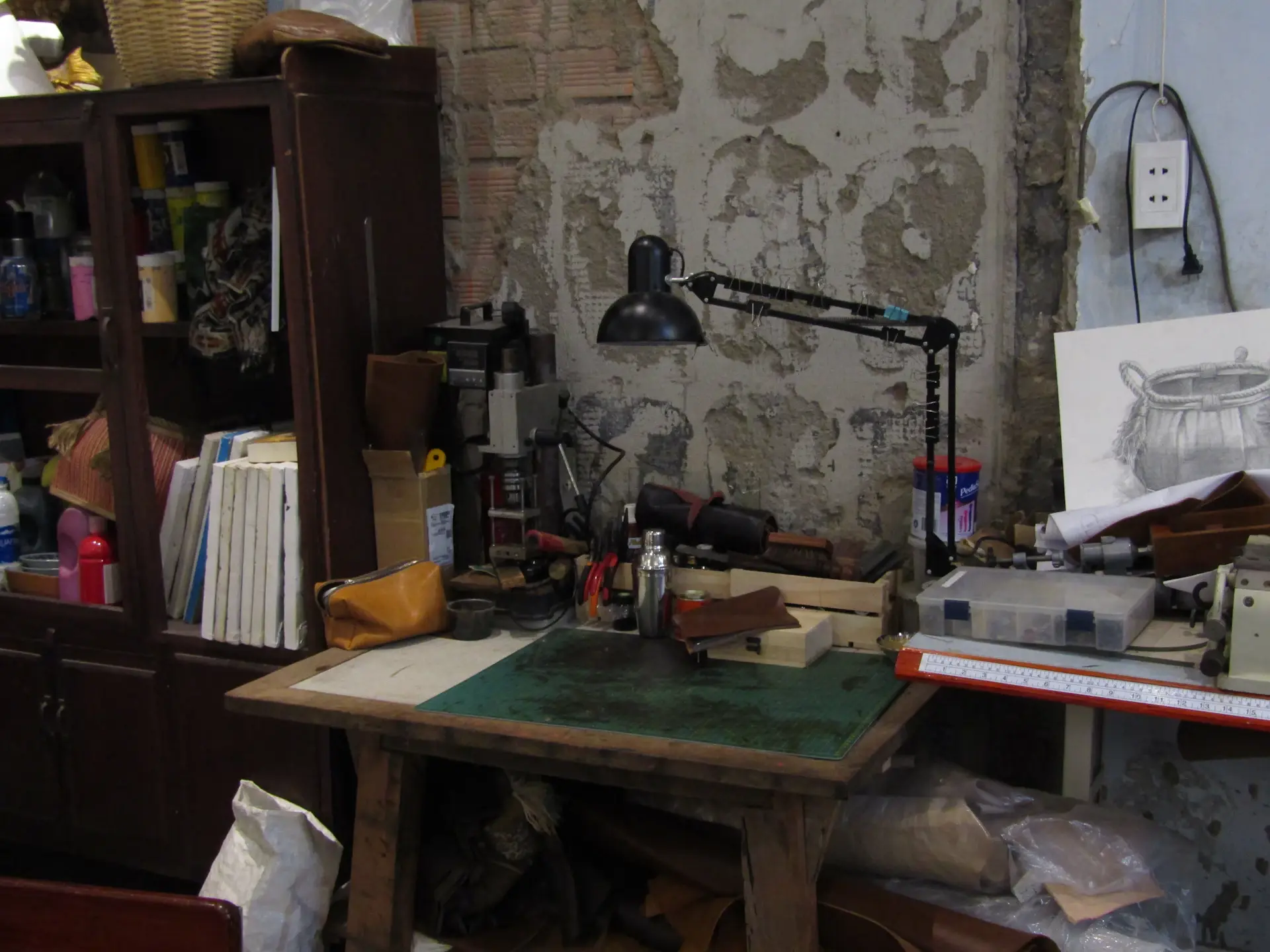 A designer's studio with hand-painted automotive renderings and sketches
