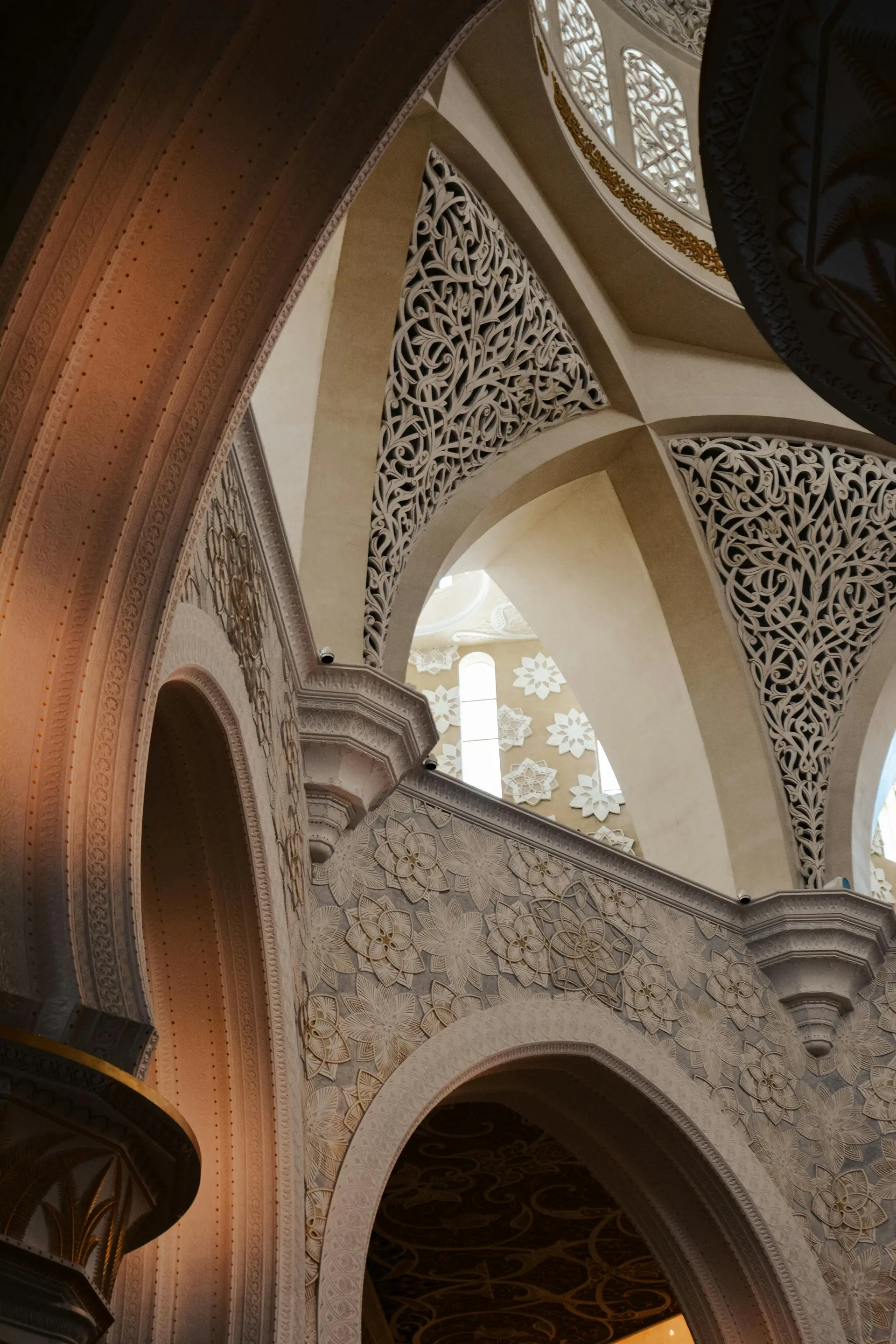 Detail of a gilded archway and crystal sconce at Aurielle