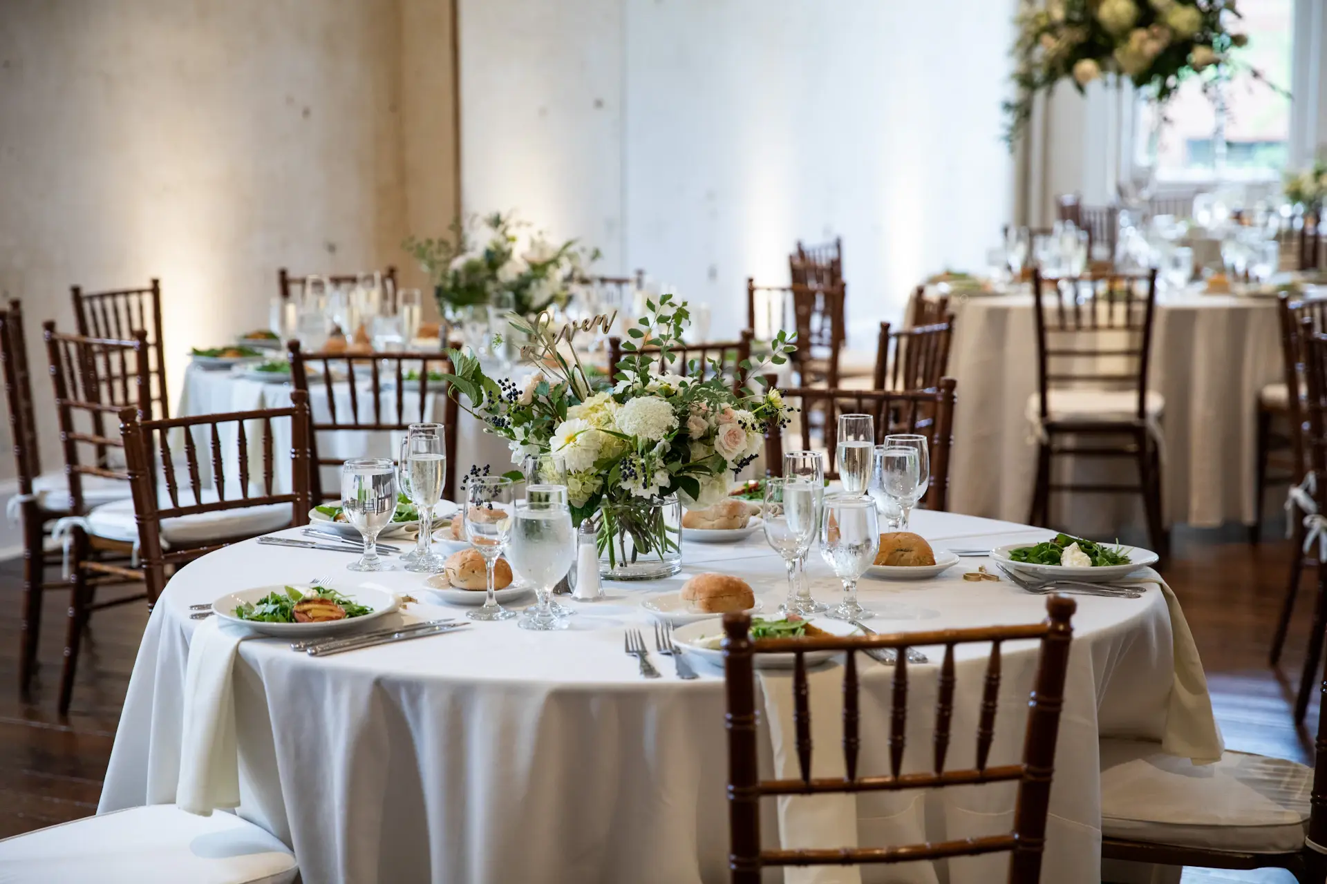 A soft ivory and champagne wedding tablescape with low candlelight