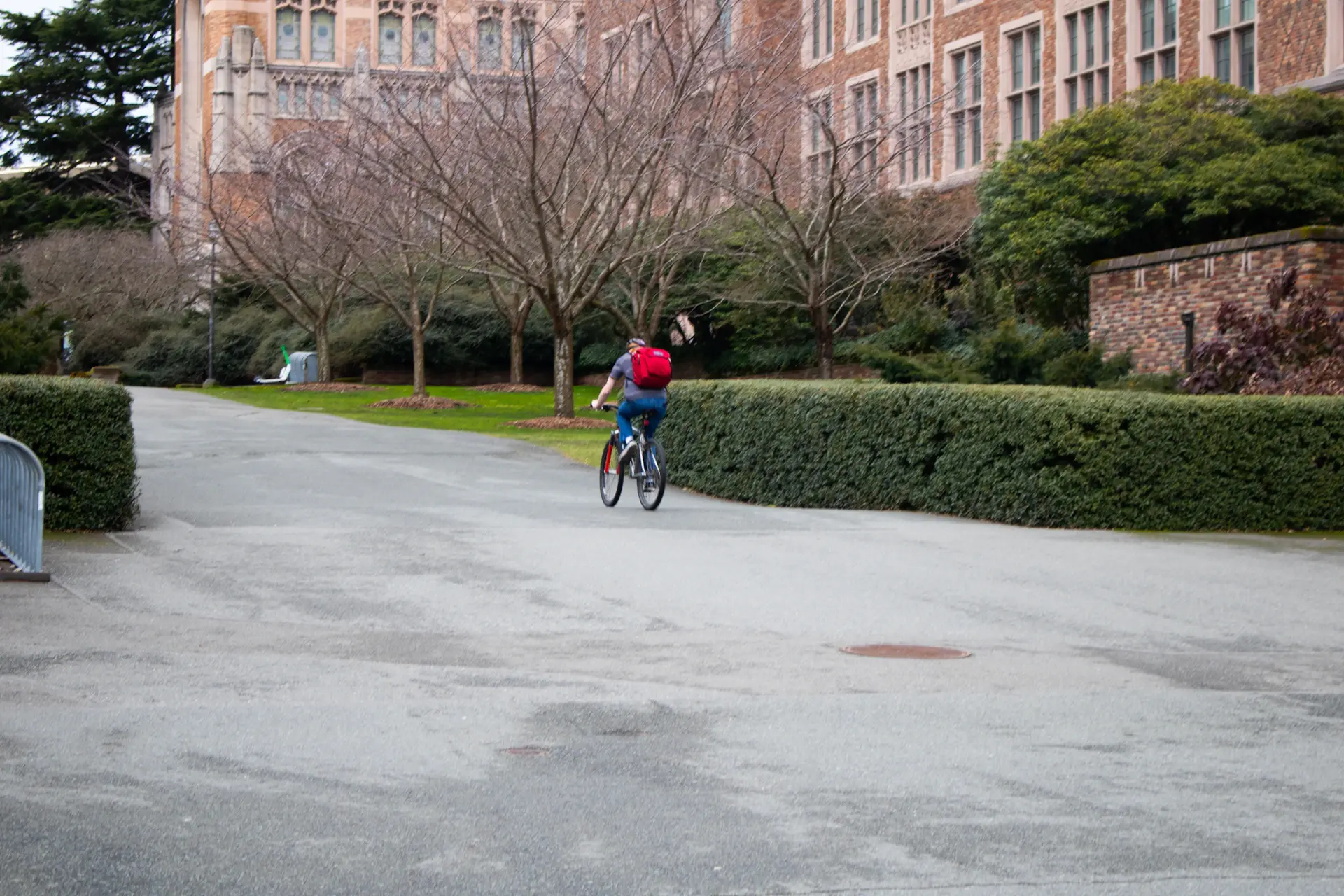 Student riding a bicycle through campus
