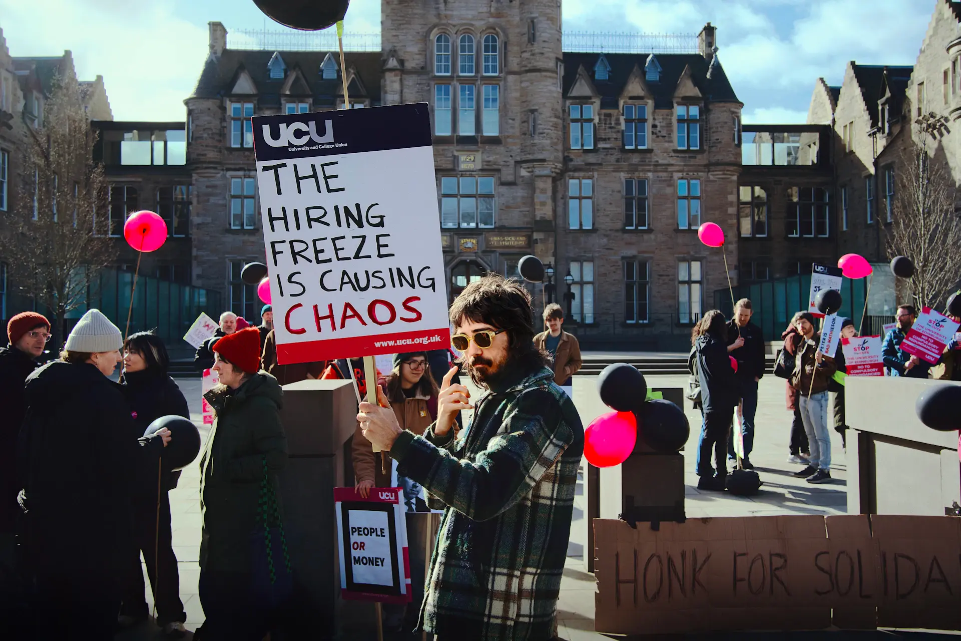 Student holding a university banner