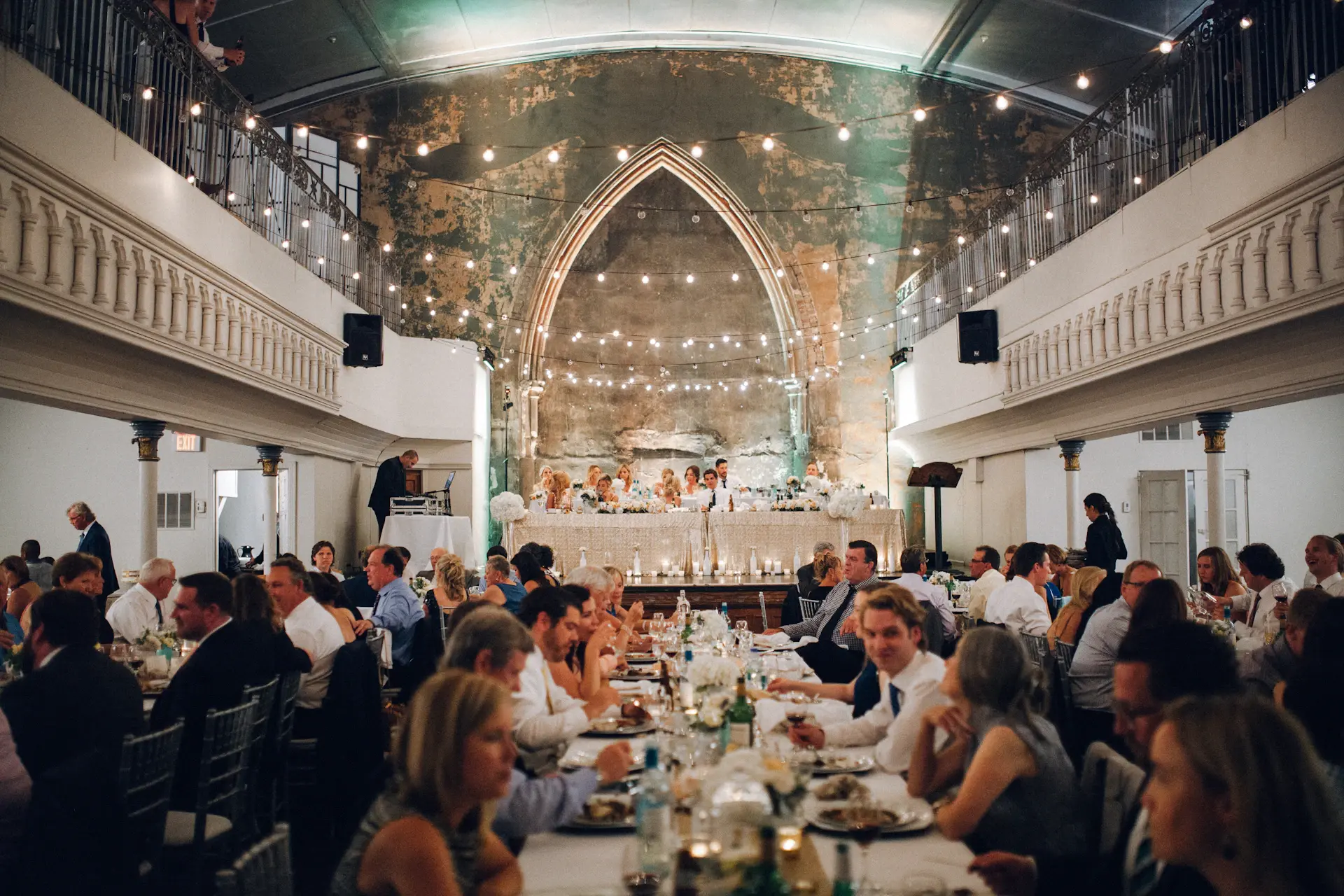 Guests seated under a vaulted gilded ceiling