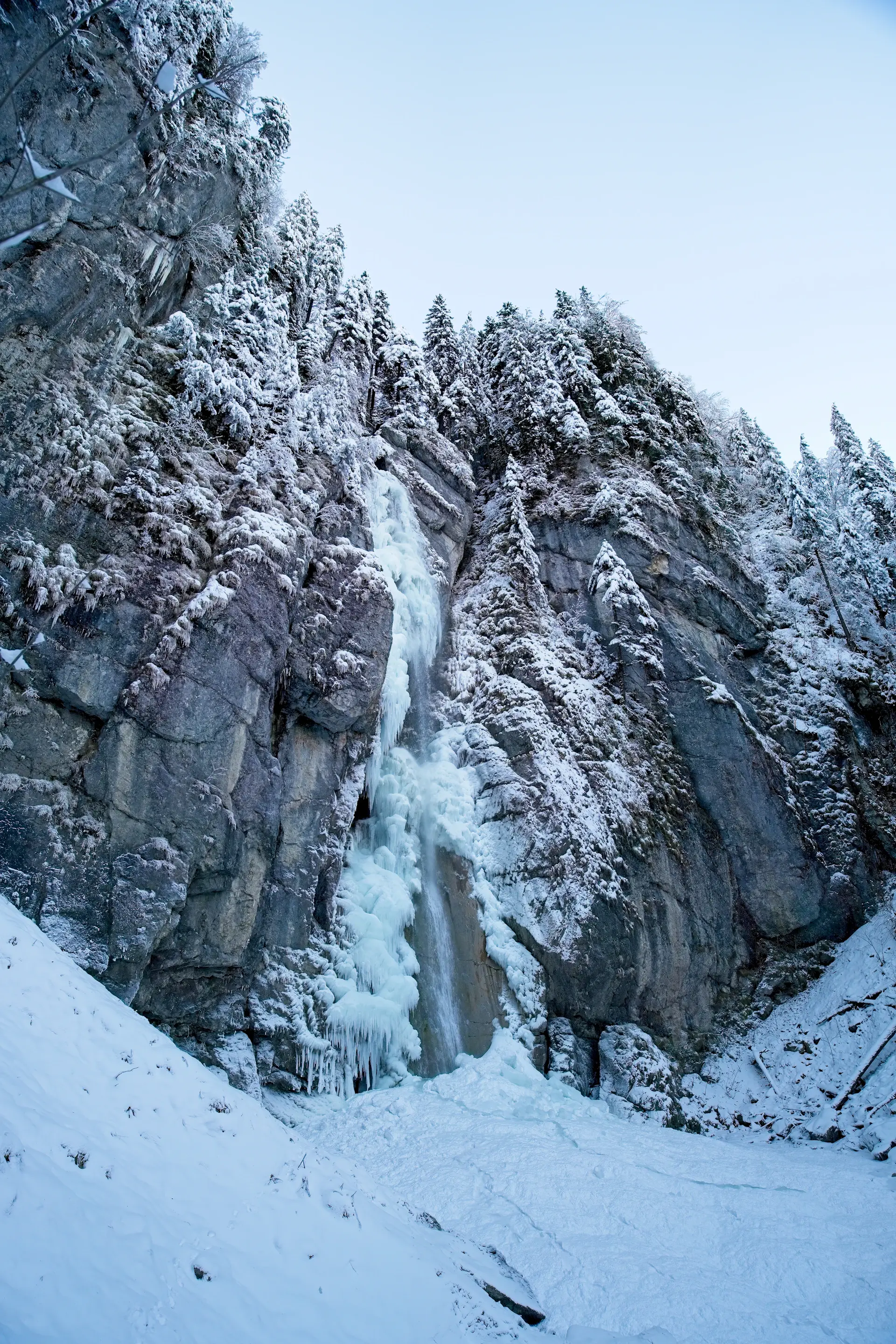 A half-frozen waterfall in winter light
