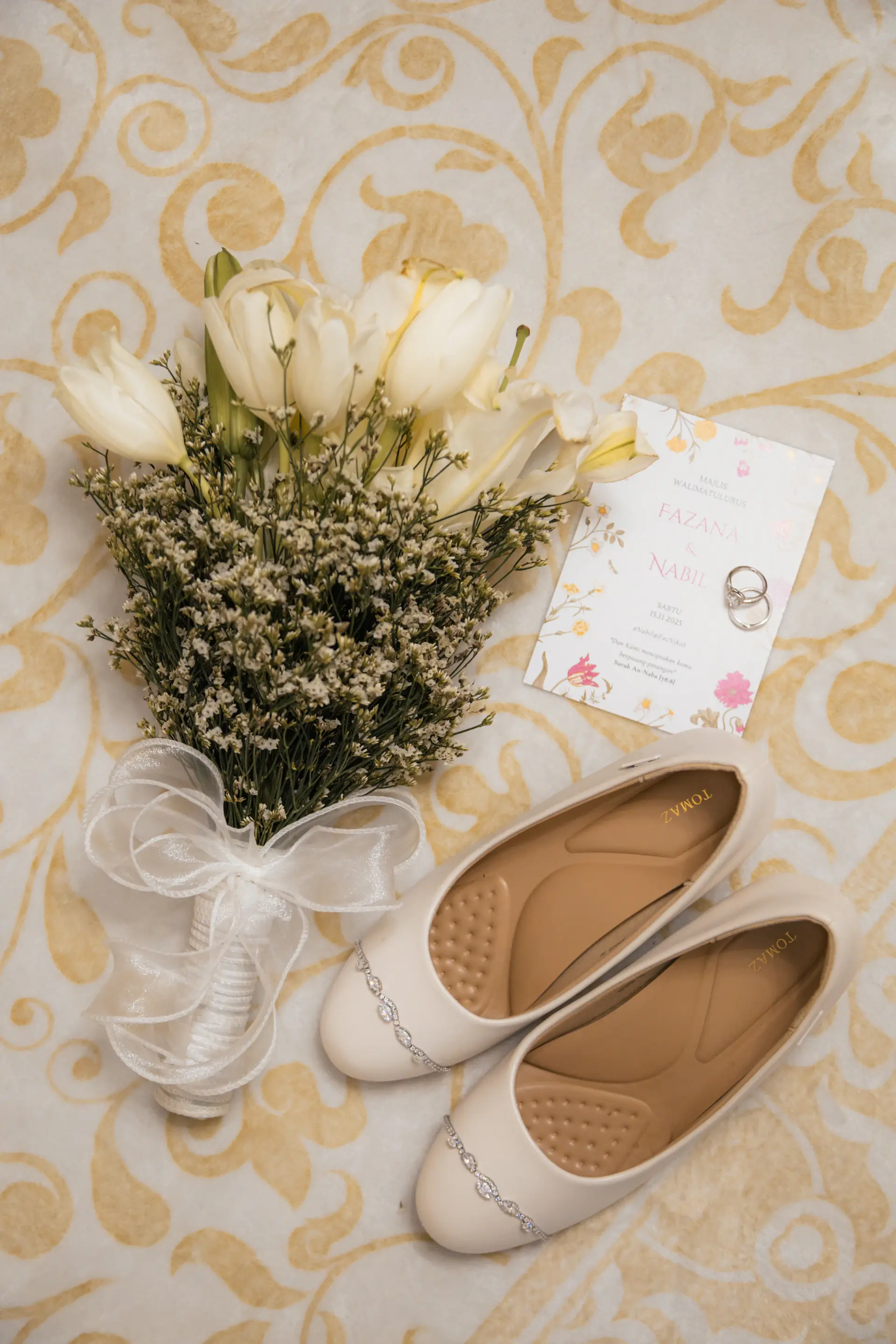 Bride's silk shoes beside the bouquet