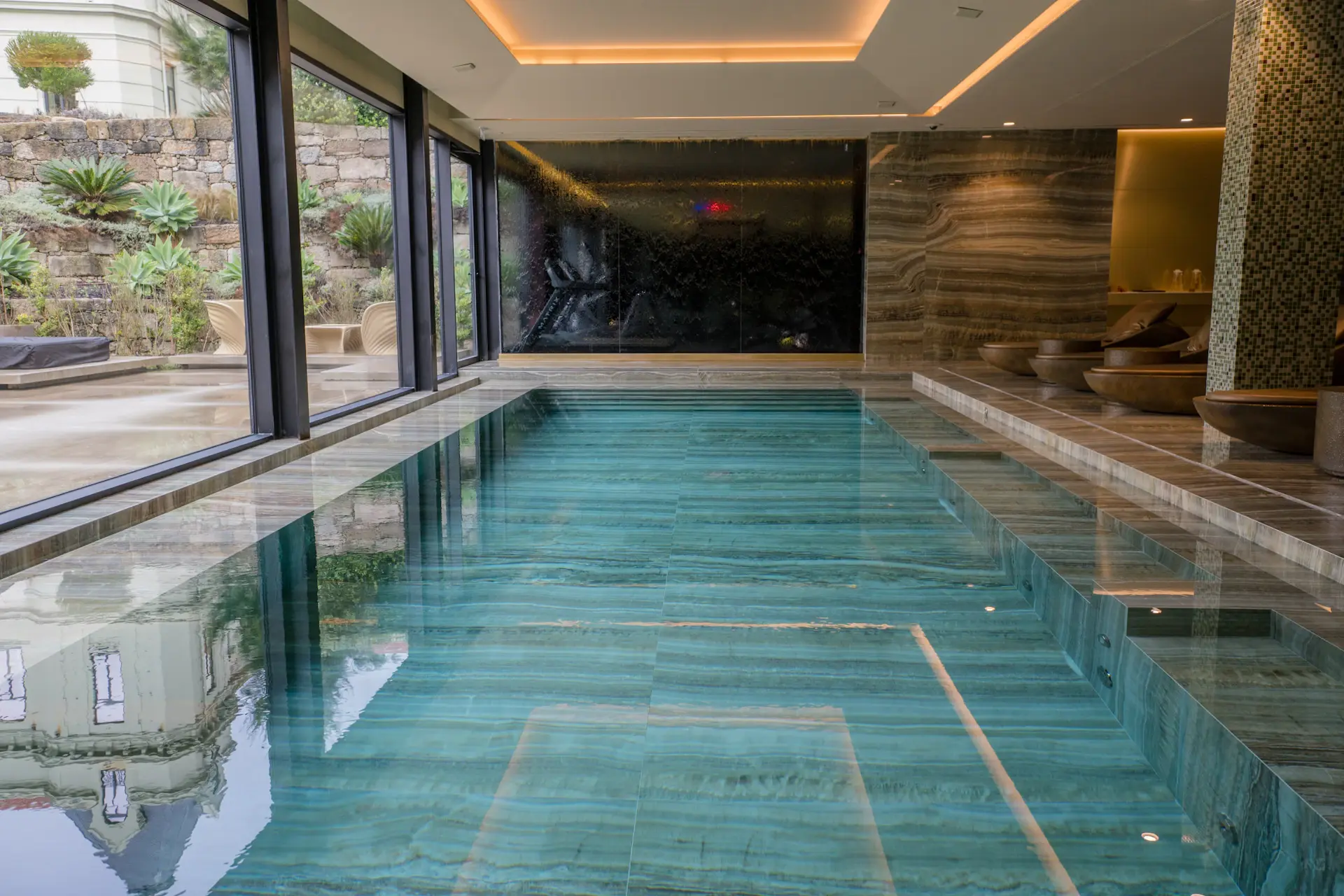 Warmly lit wellness residence interior with marble and soft fabric