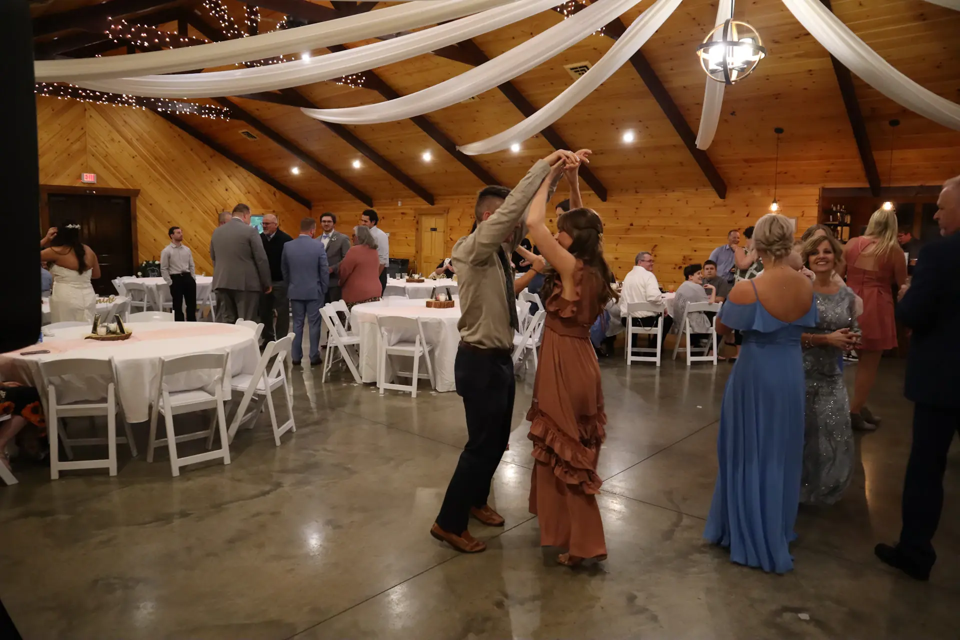 Guests dancing under chandelier light