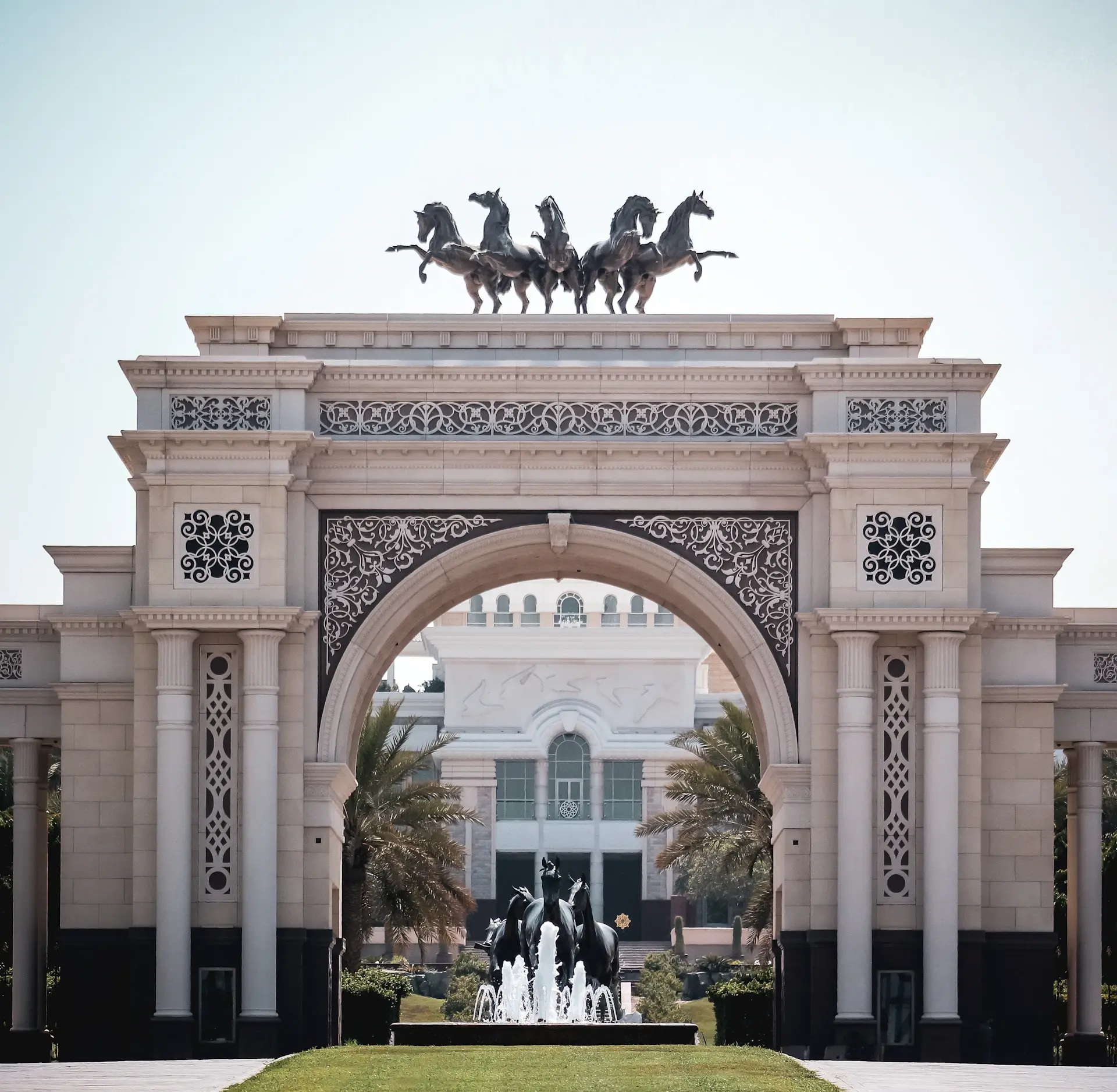Bride and groom beneath a golden archway