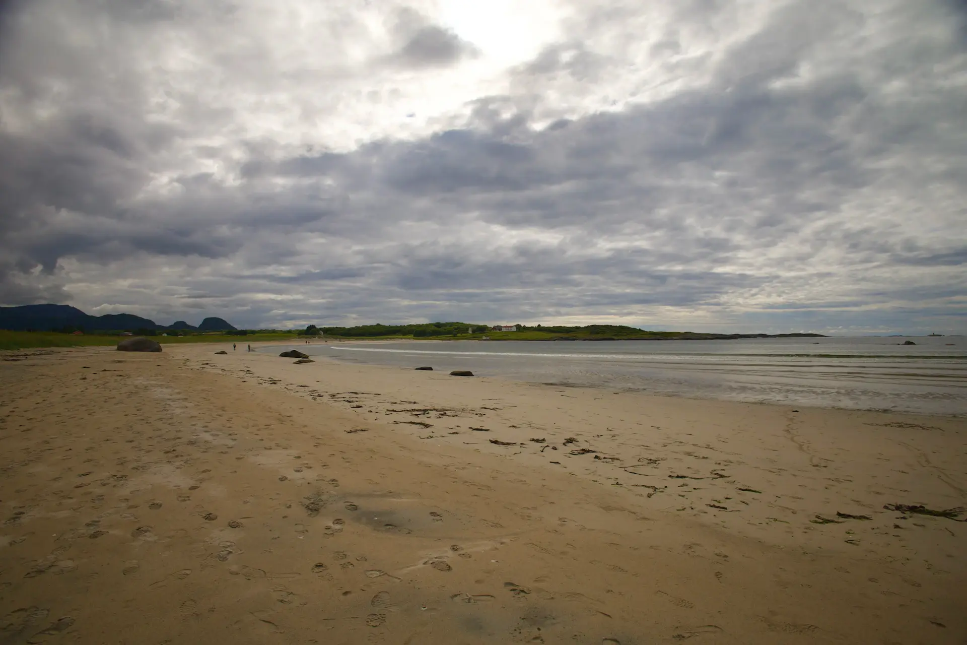 Tide-flat shoreline glowing under a vast empty sky
