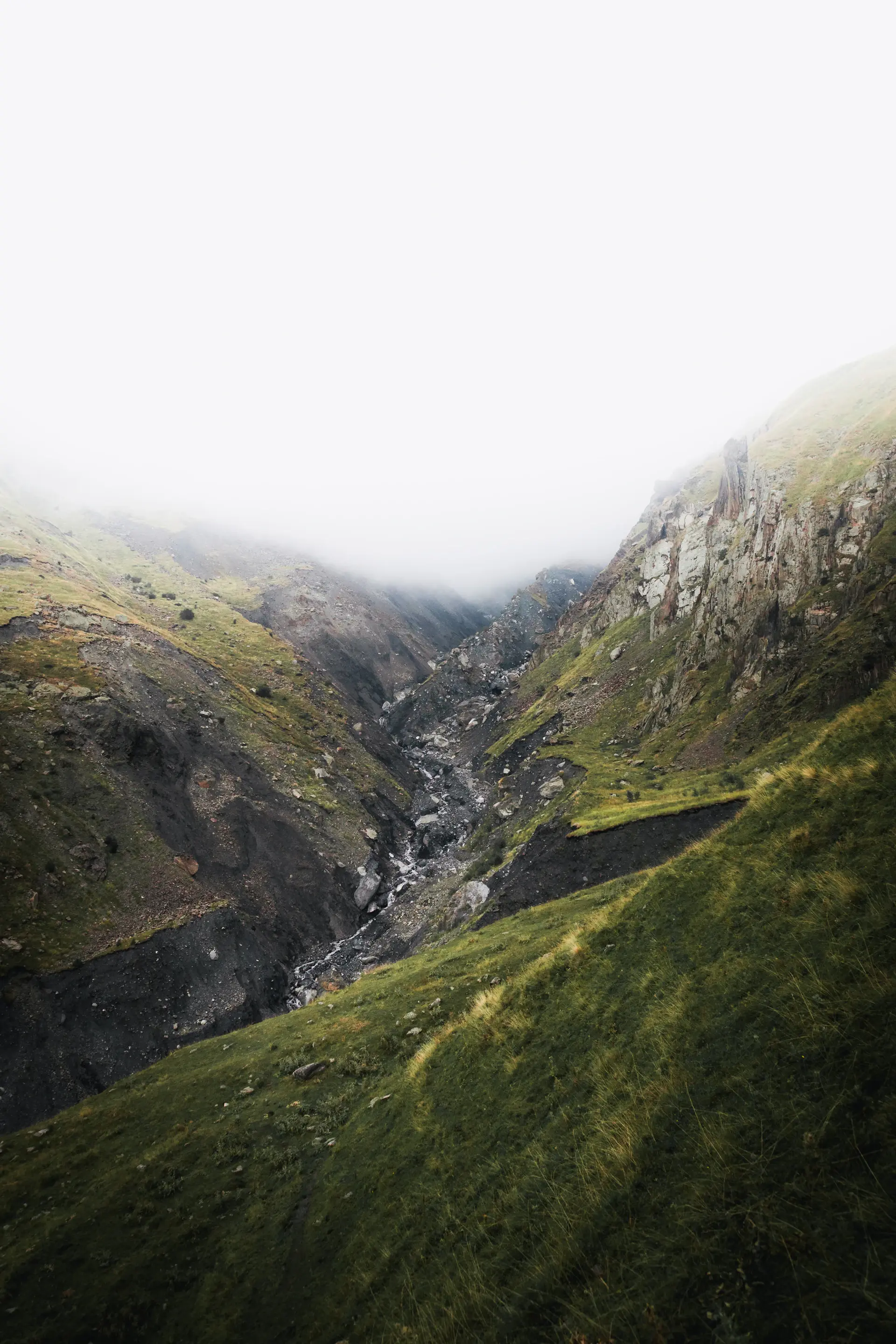 A quiet valley wrapped in soft mountain mist