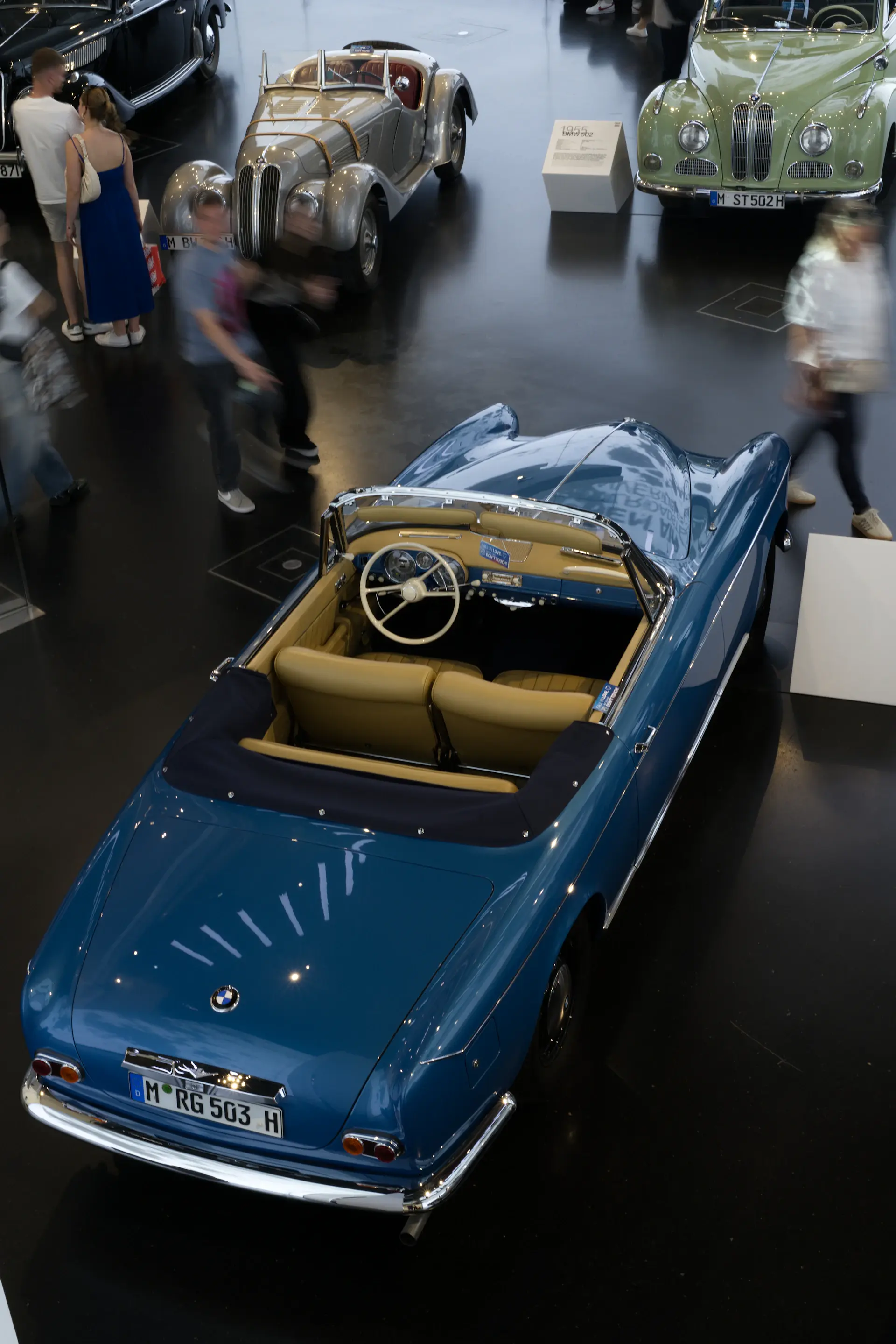 A 1980s convertible motorcar with the roof folded down