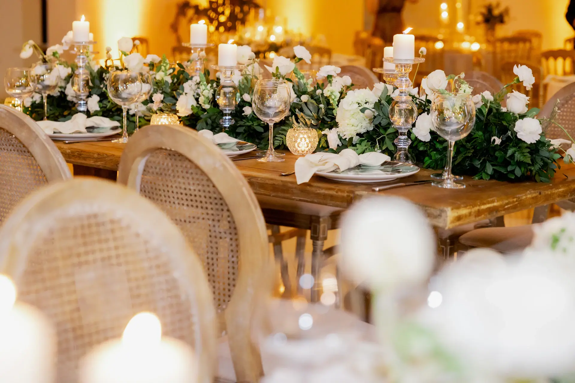 A long banquet table dressed with candles and florals