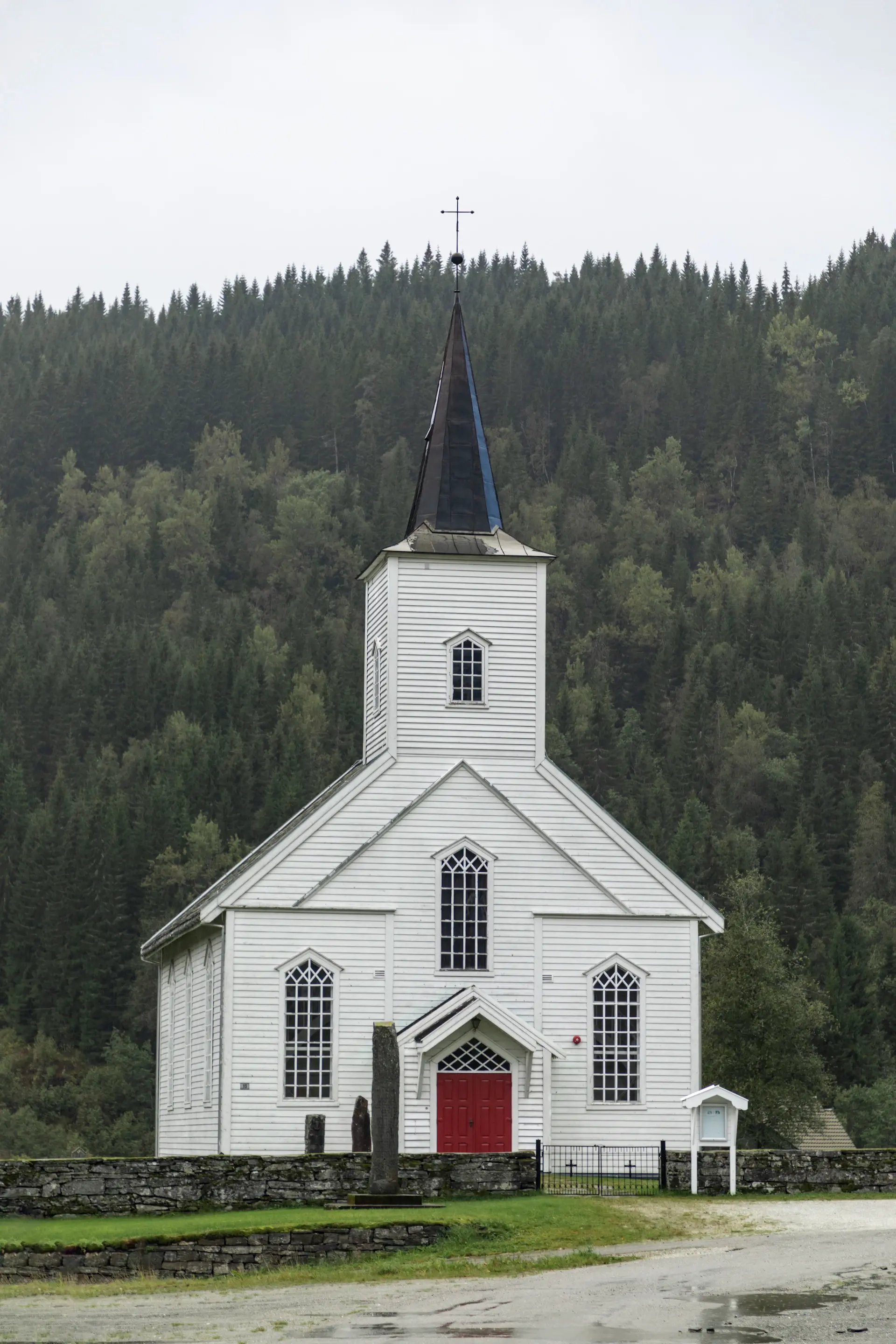 A quiet island church on a mist-soft alpine lake