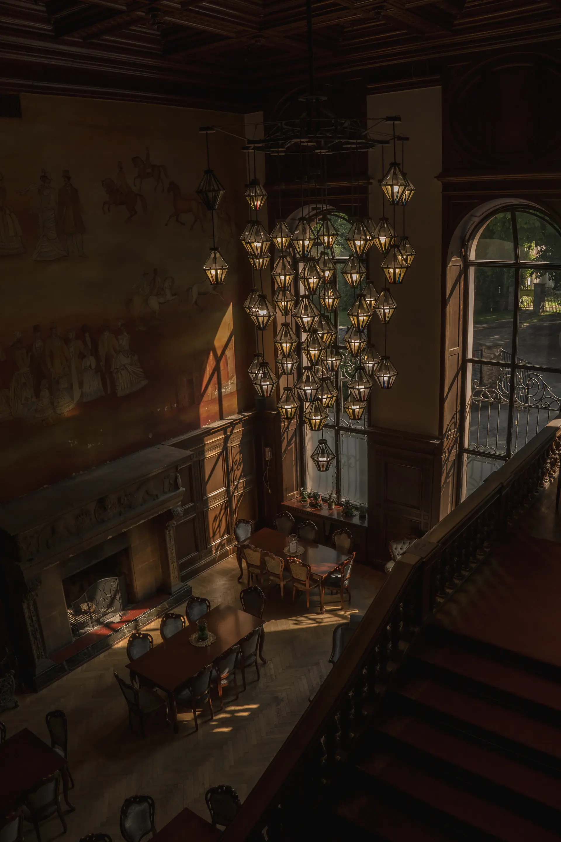Refined estate interior with tall windows and warm light