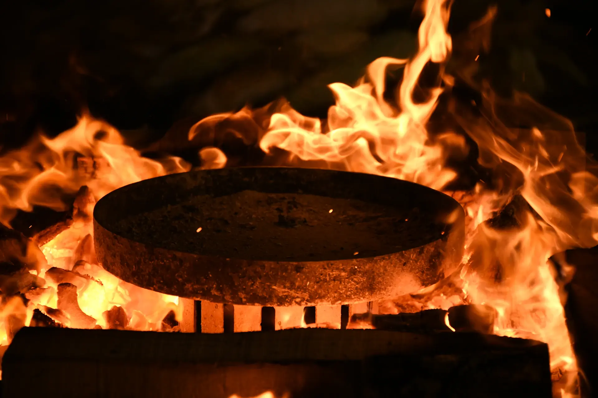 Flames licking the inside of a freshly built oak cask