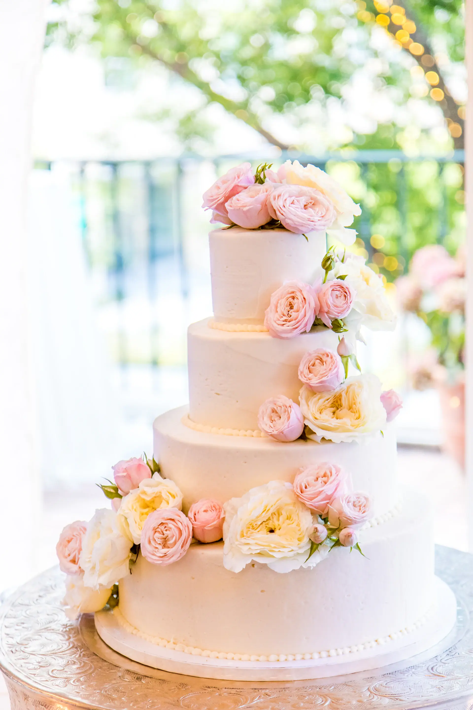 Tiered ivory wedding cake with florals