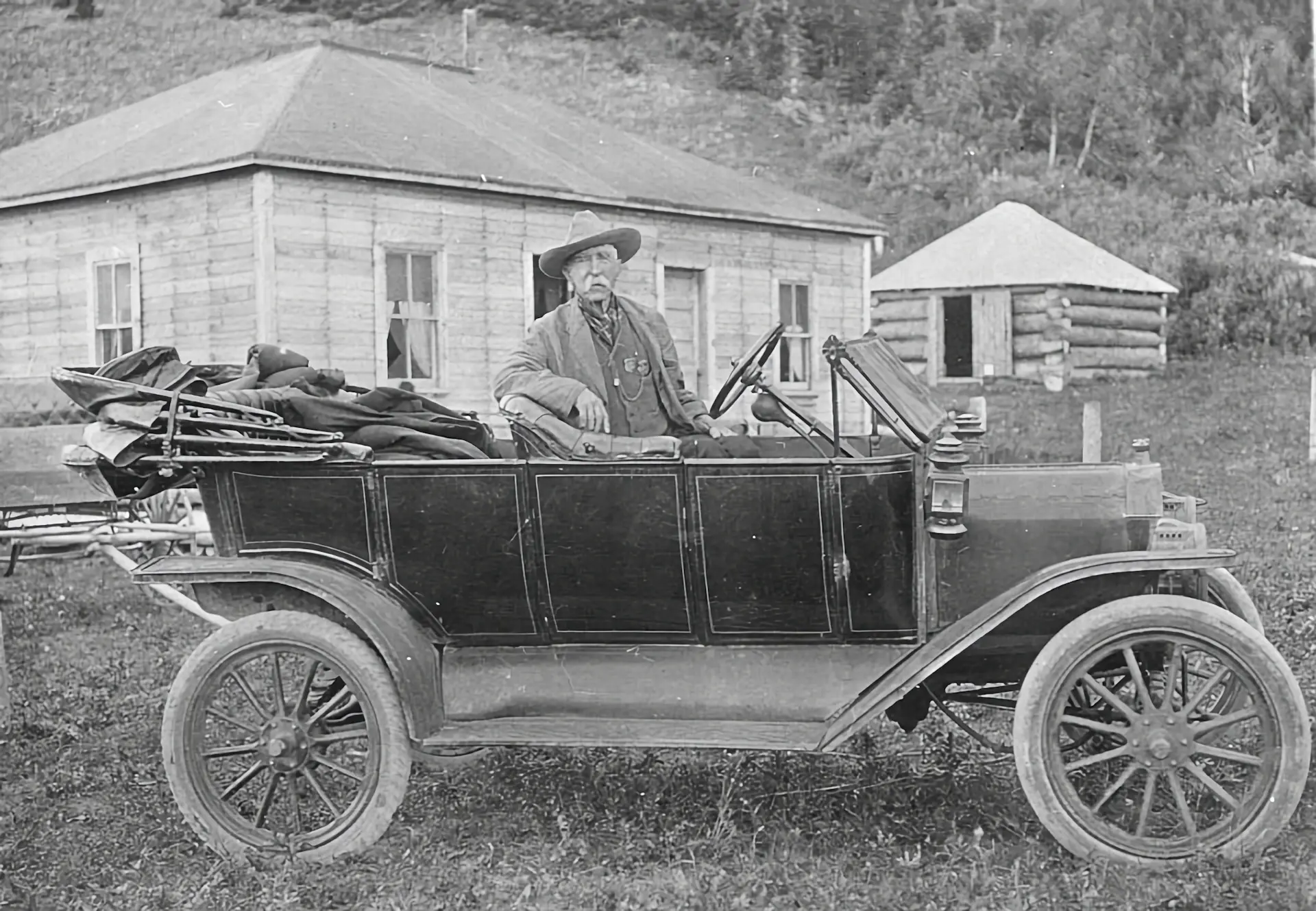 An early hand-built motorcar from the marque's founding era, photographed in archival sepia