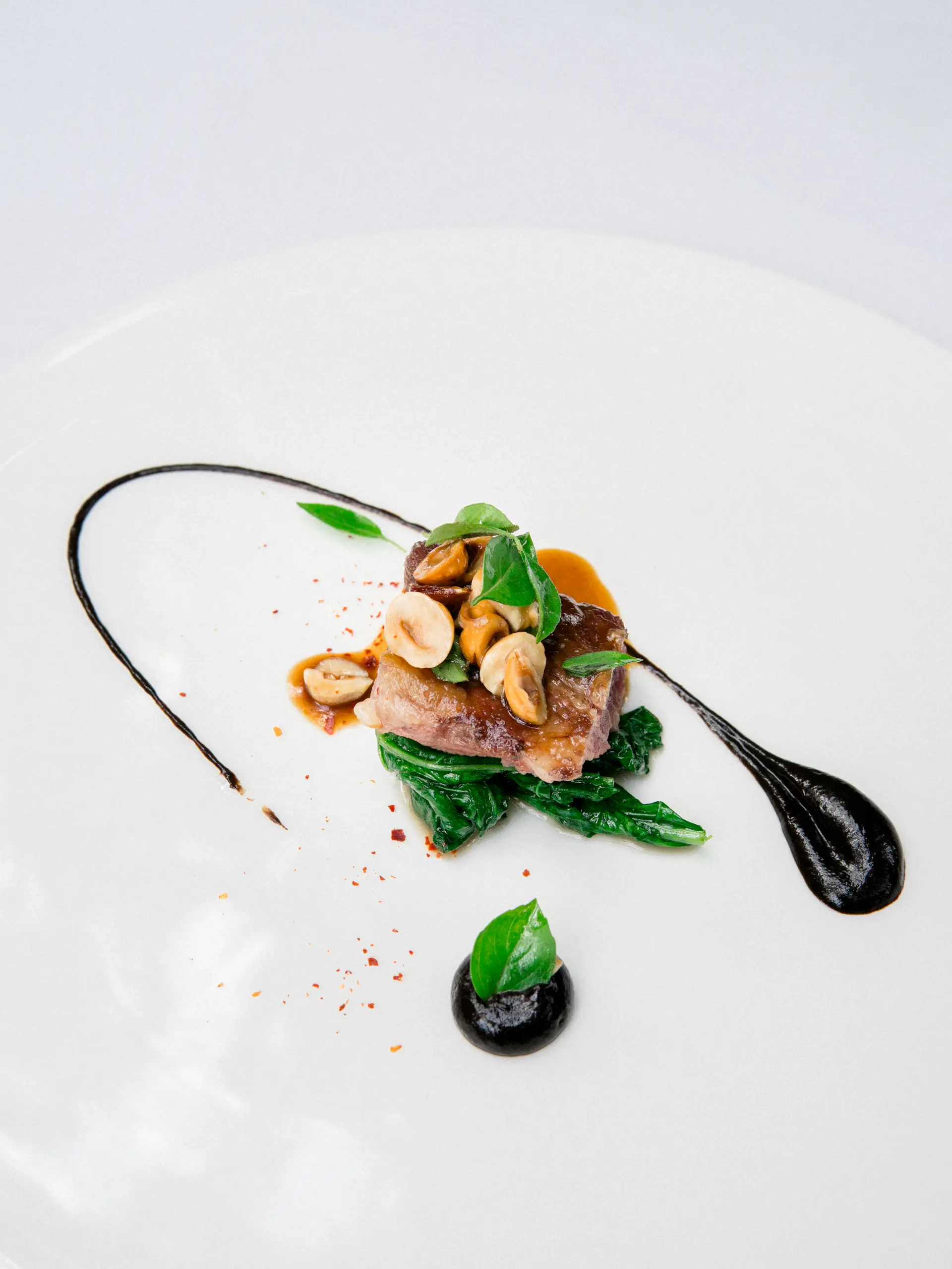 A chef plating an exquisite course beneath warm golden light