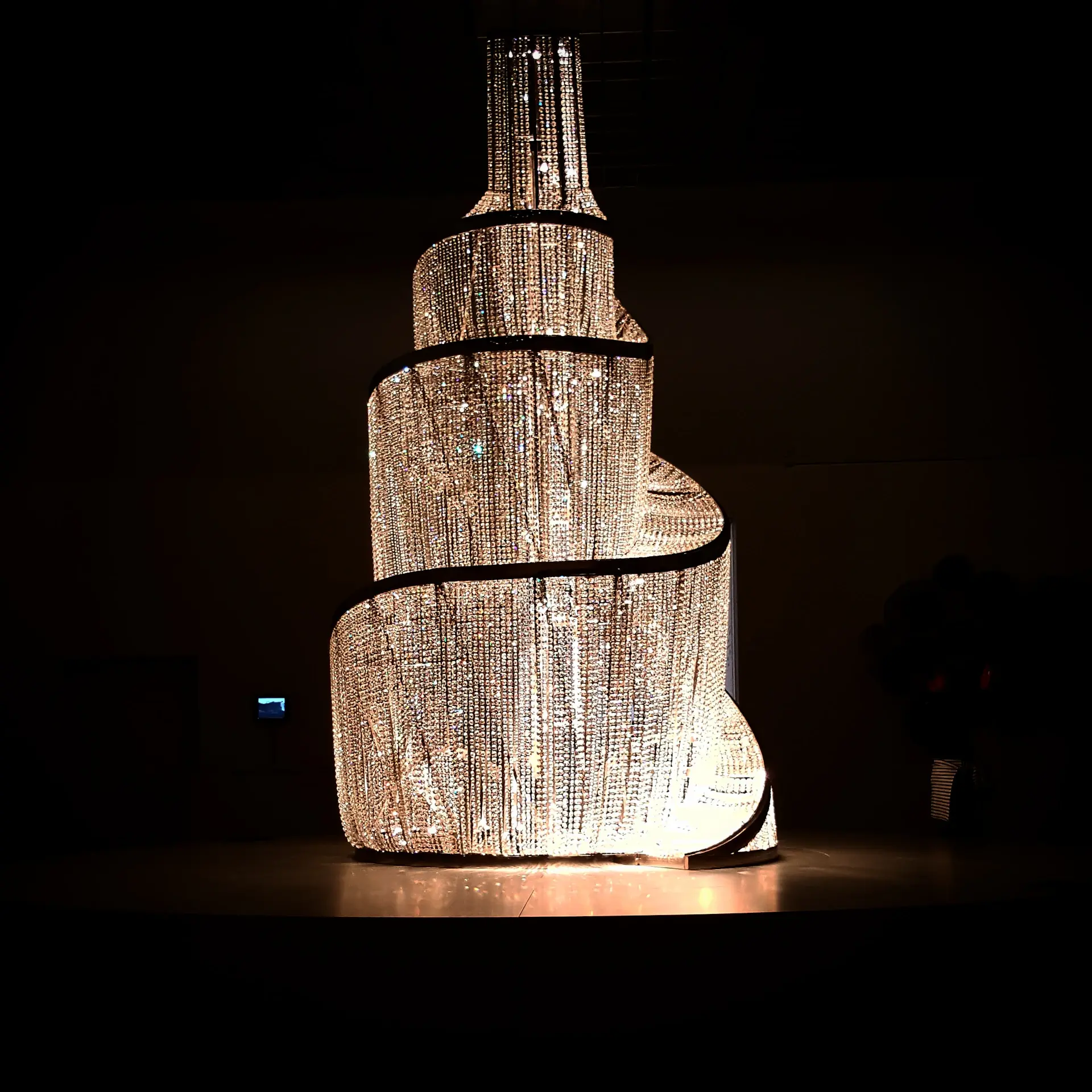 A glittering champagne tower being poured at a luxury reception