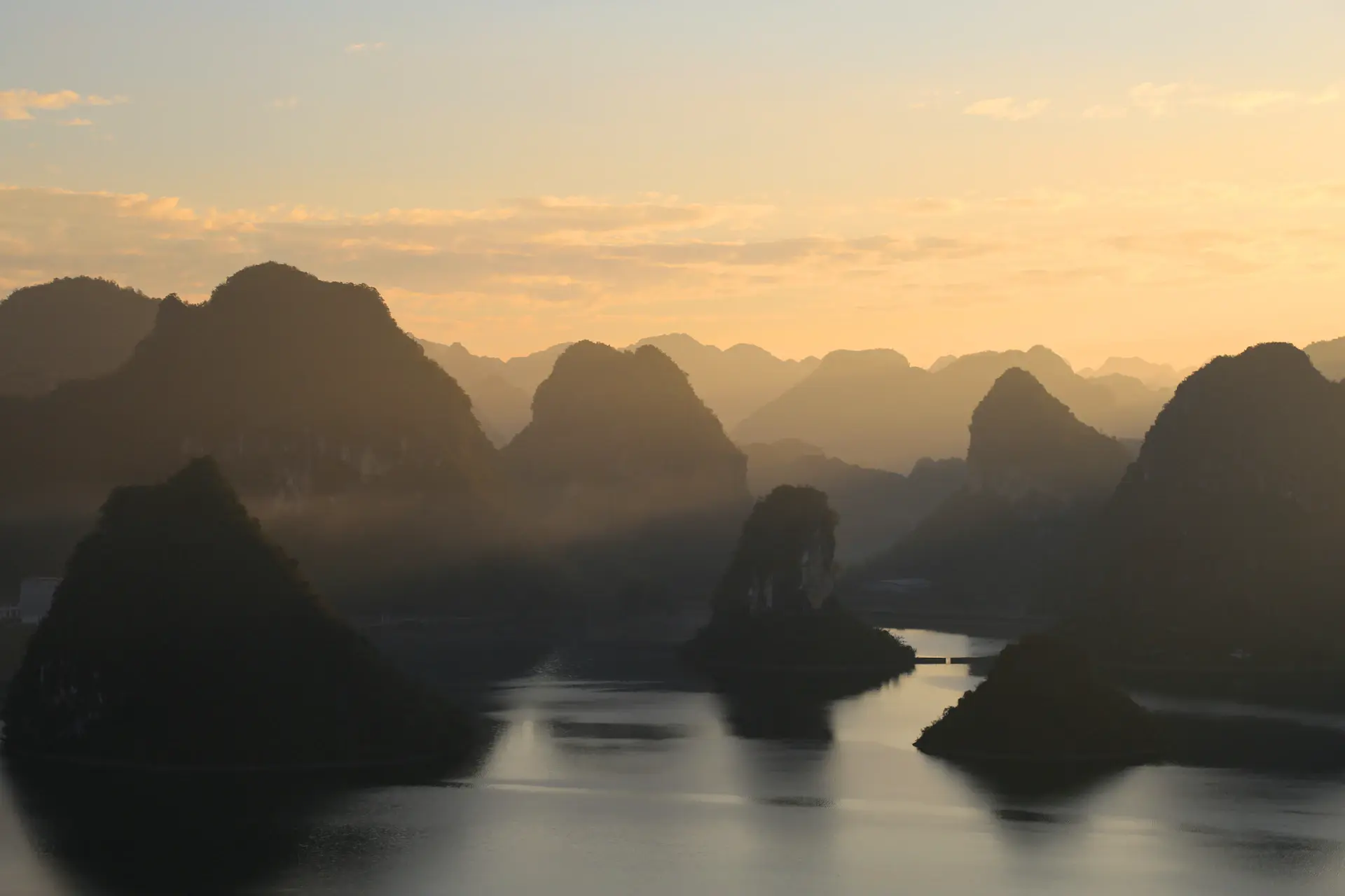 The Great Wall of China stretching across misty mountains at sunrise