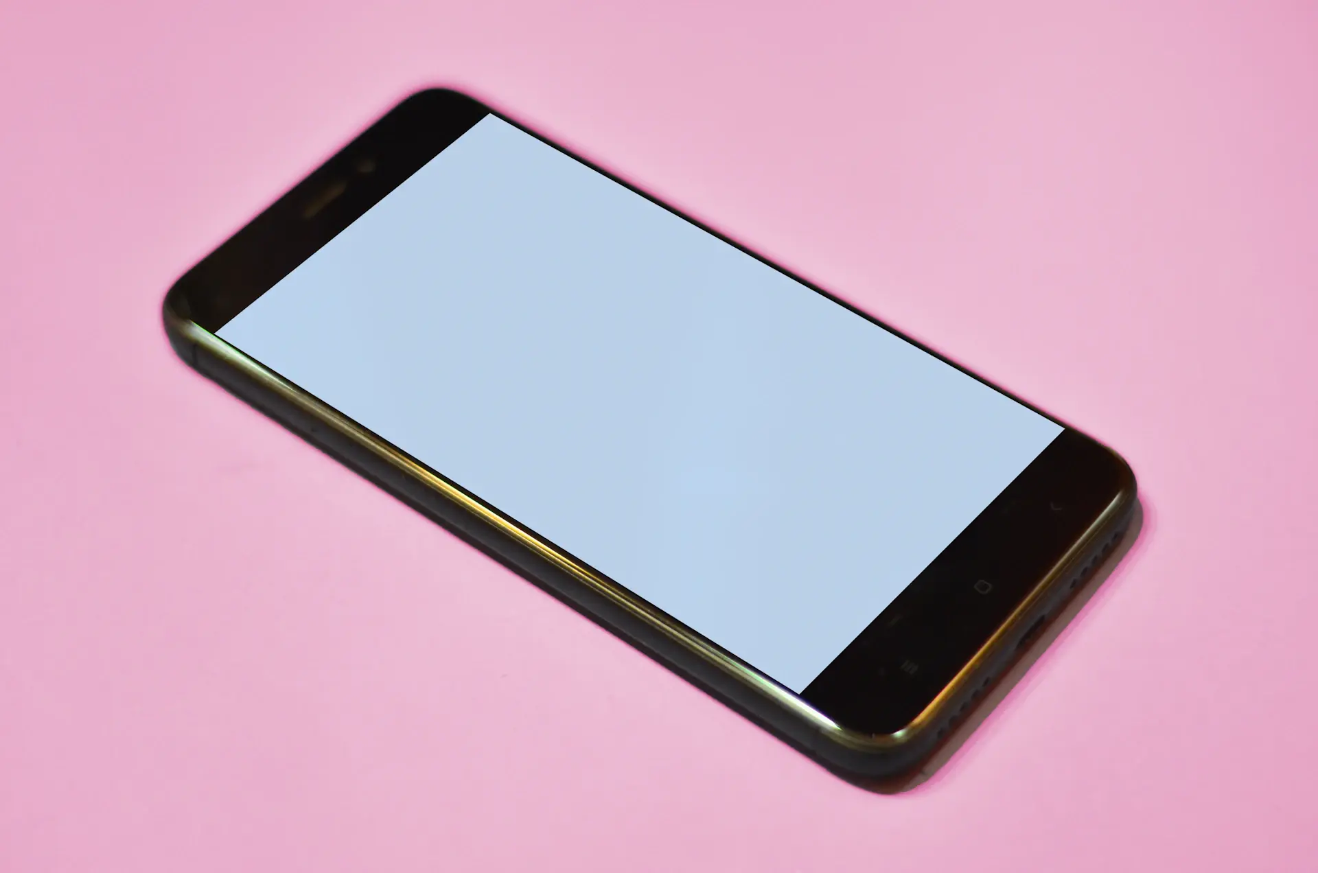 Bright minimal close-up of a phone showing a clean multi-currency balance view