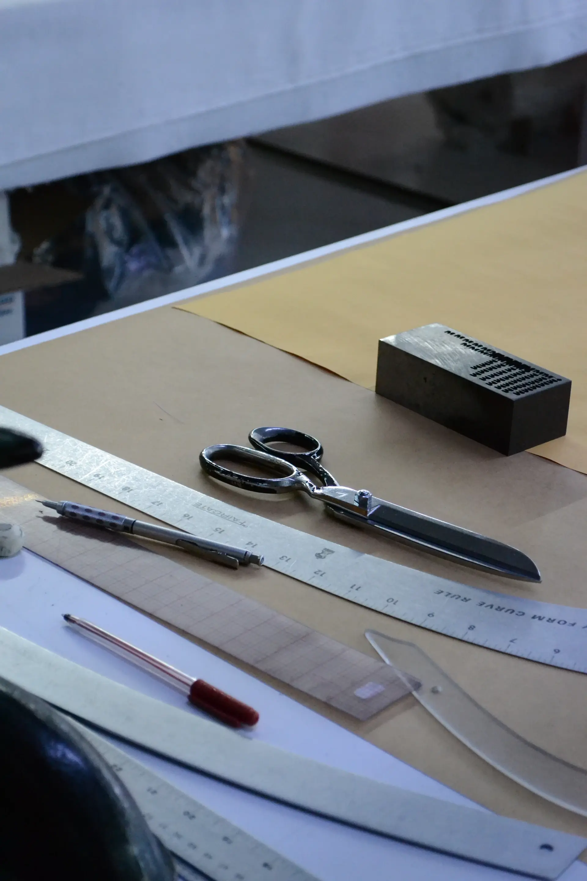 An artisan hand-stitching leather upholstery in the atelier