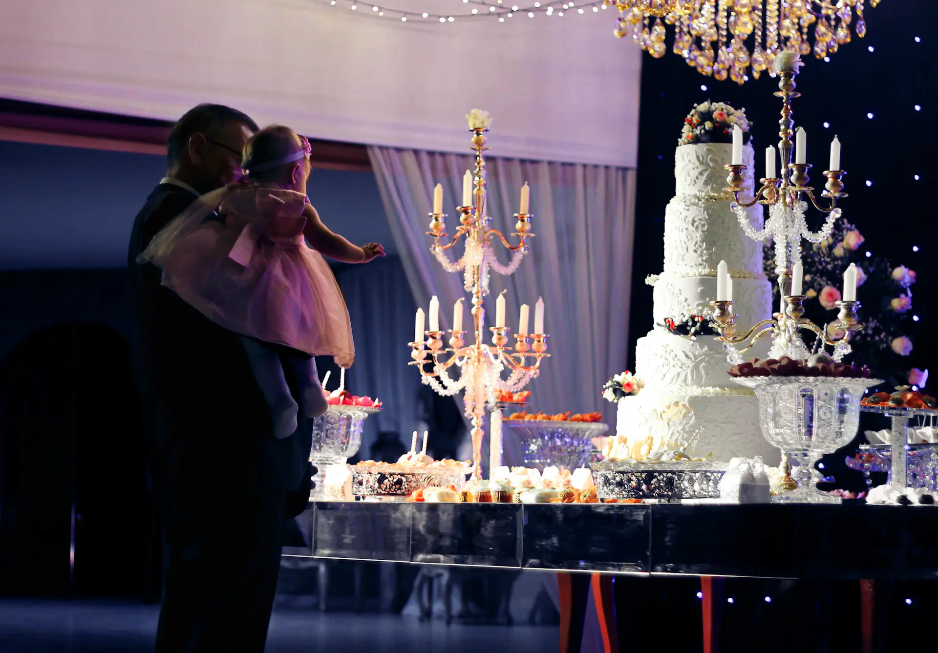 Couple's first dance beneath chandeliers
