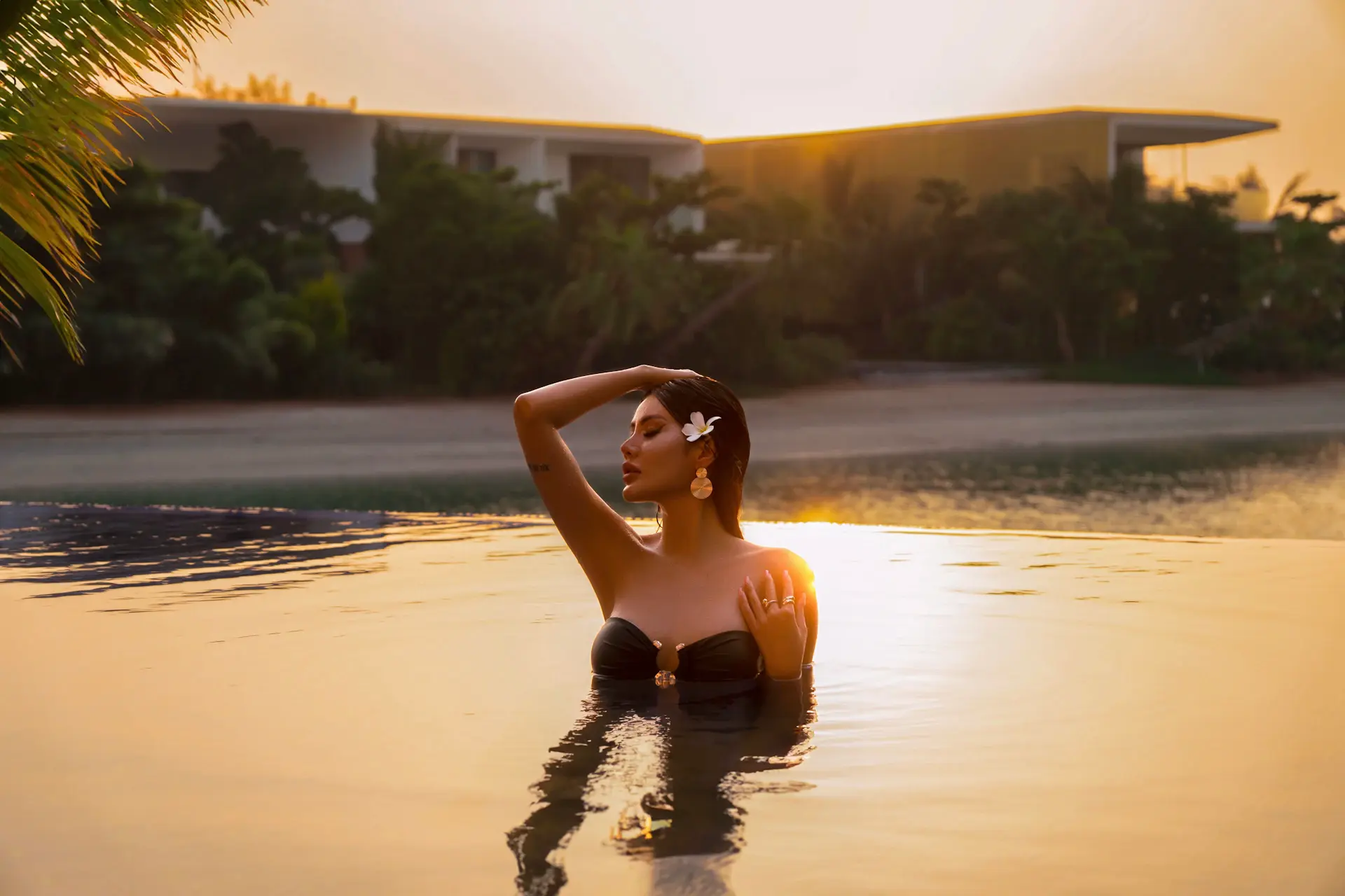 Beachfront villa with infinity pool at golden hour