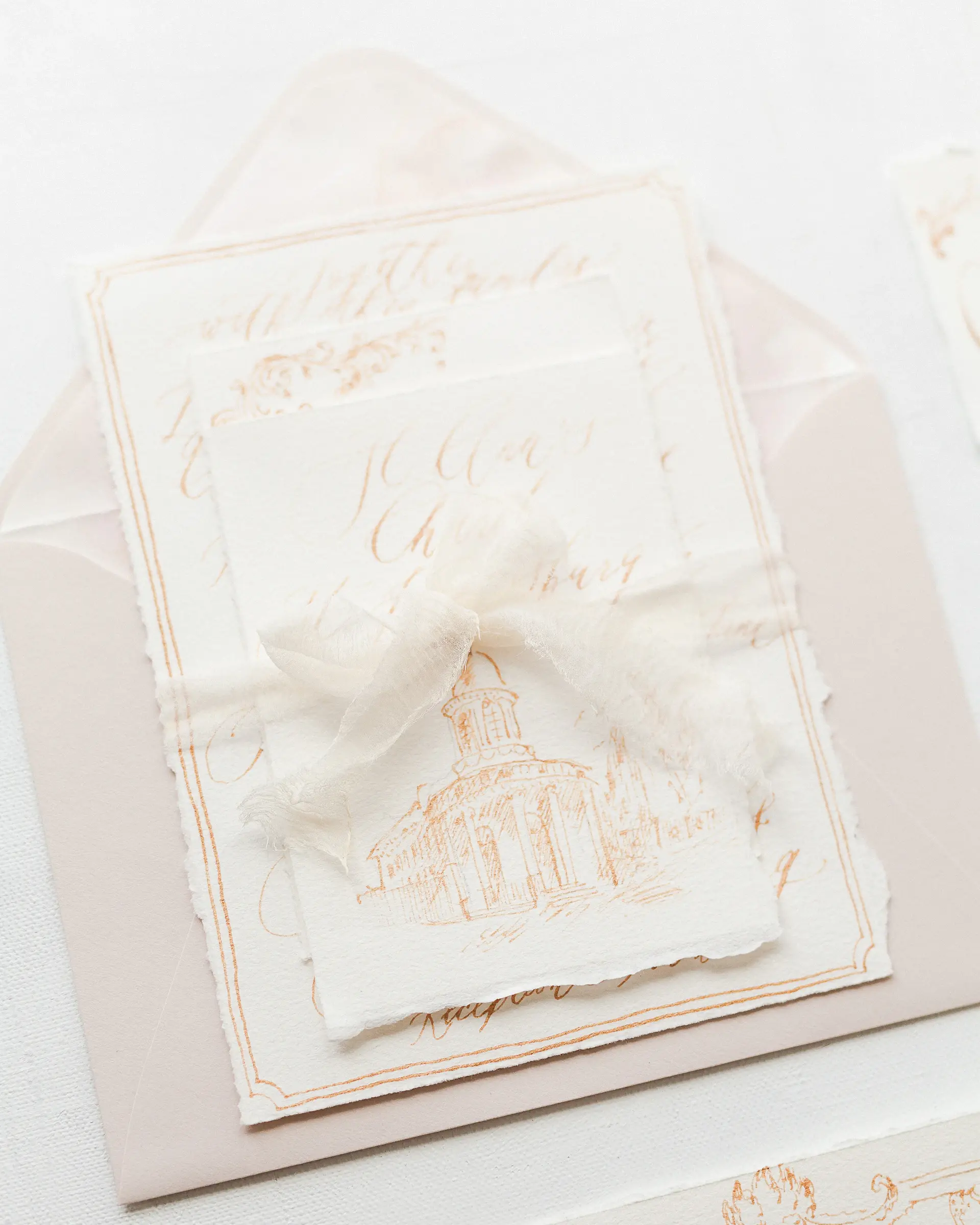 A planning desk with invitations, ribbon and swatches