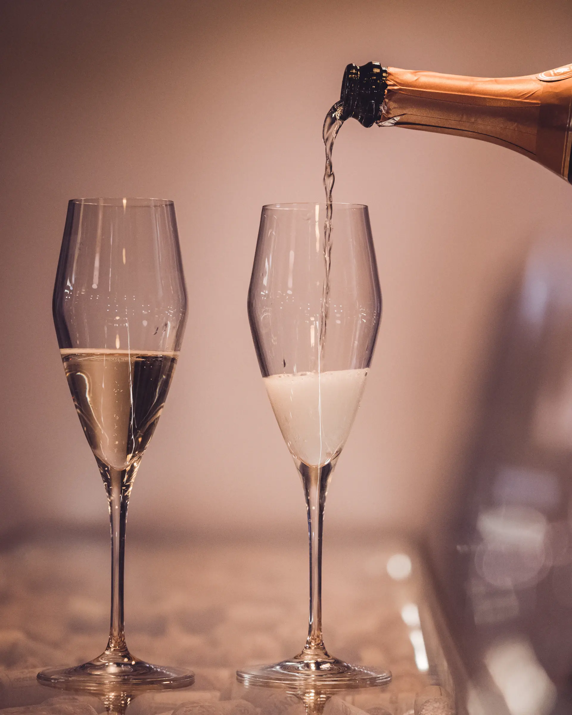 Late-night celebration with a glowing champagne tower