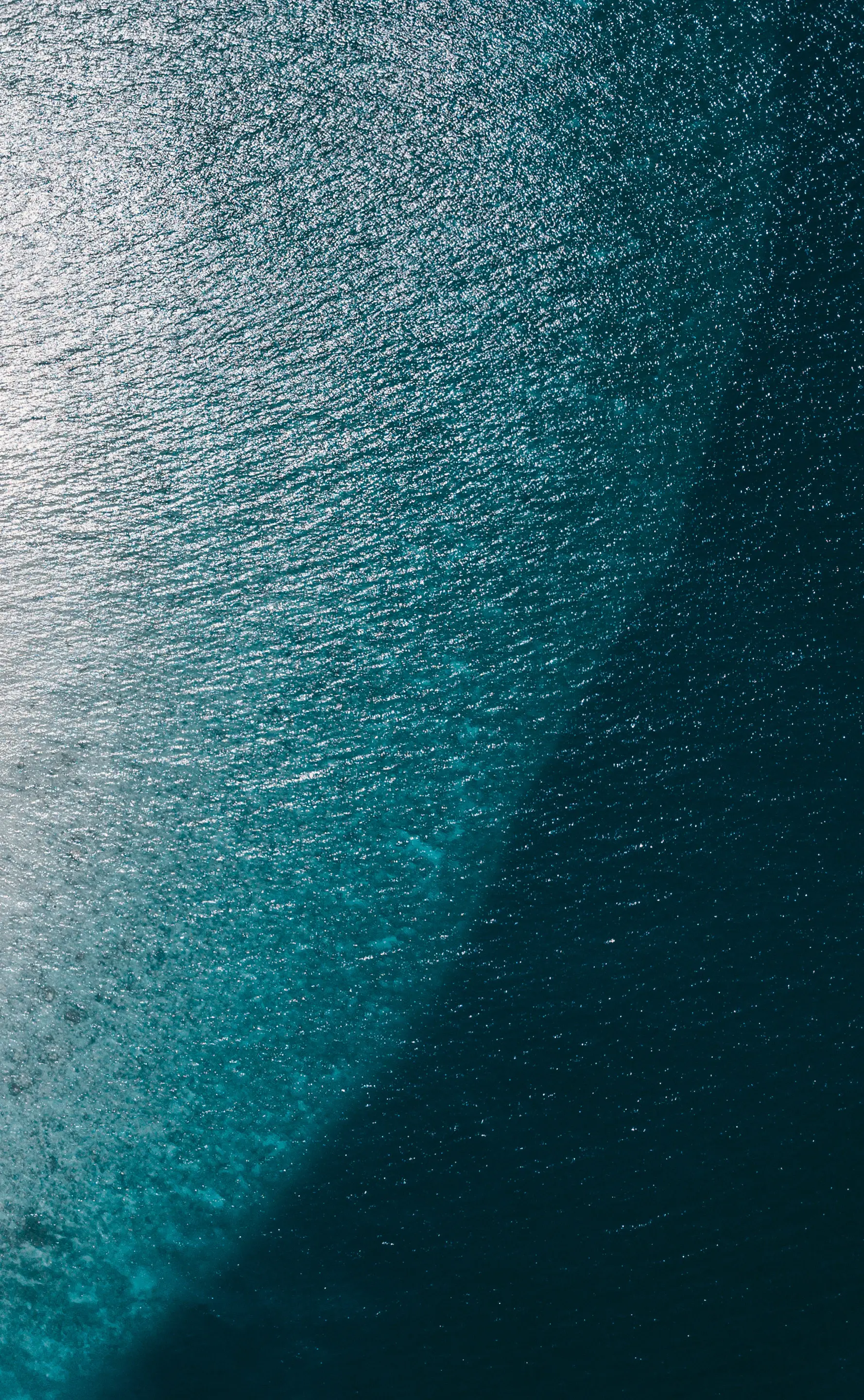 Sunlight fading into deep blue beneath the ocean surface