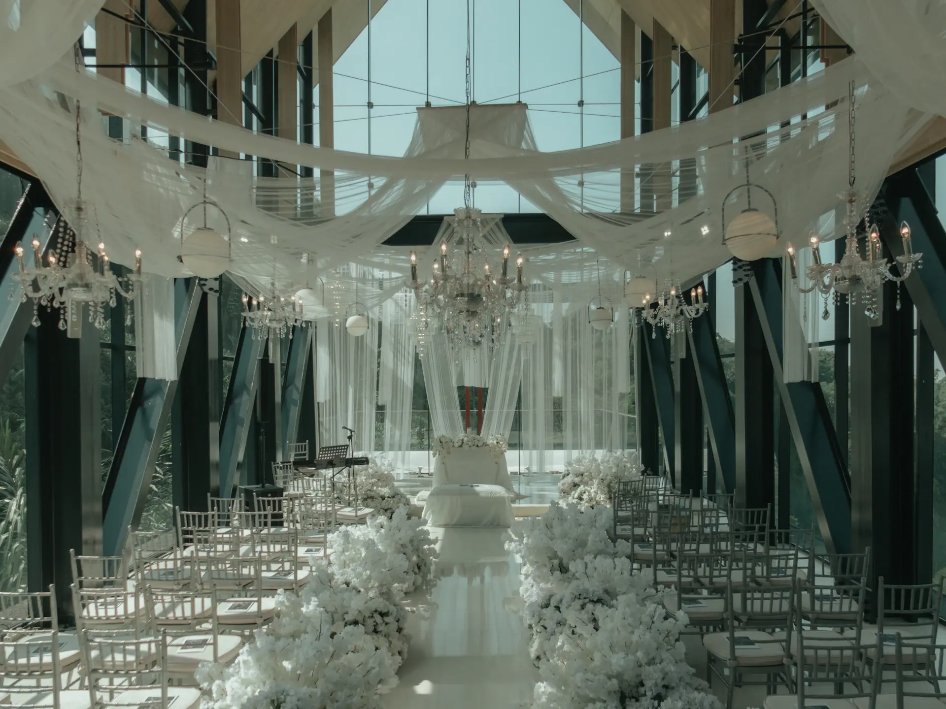 A ceremony set beneath a glass atrium dome