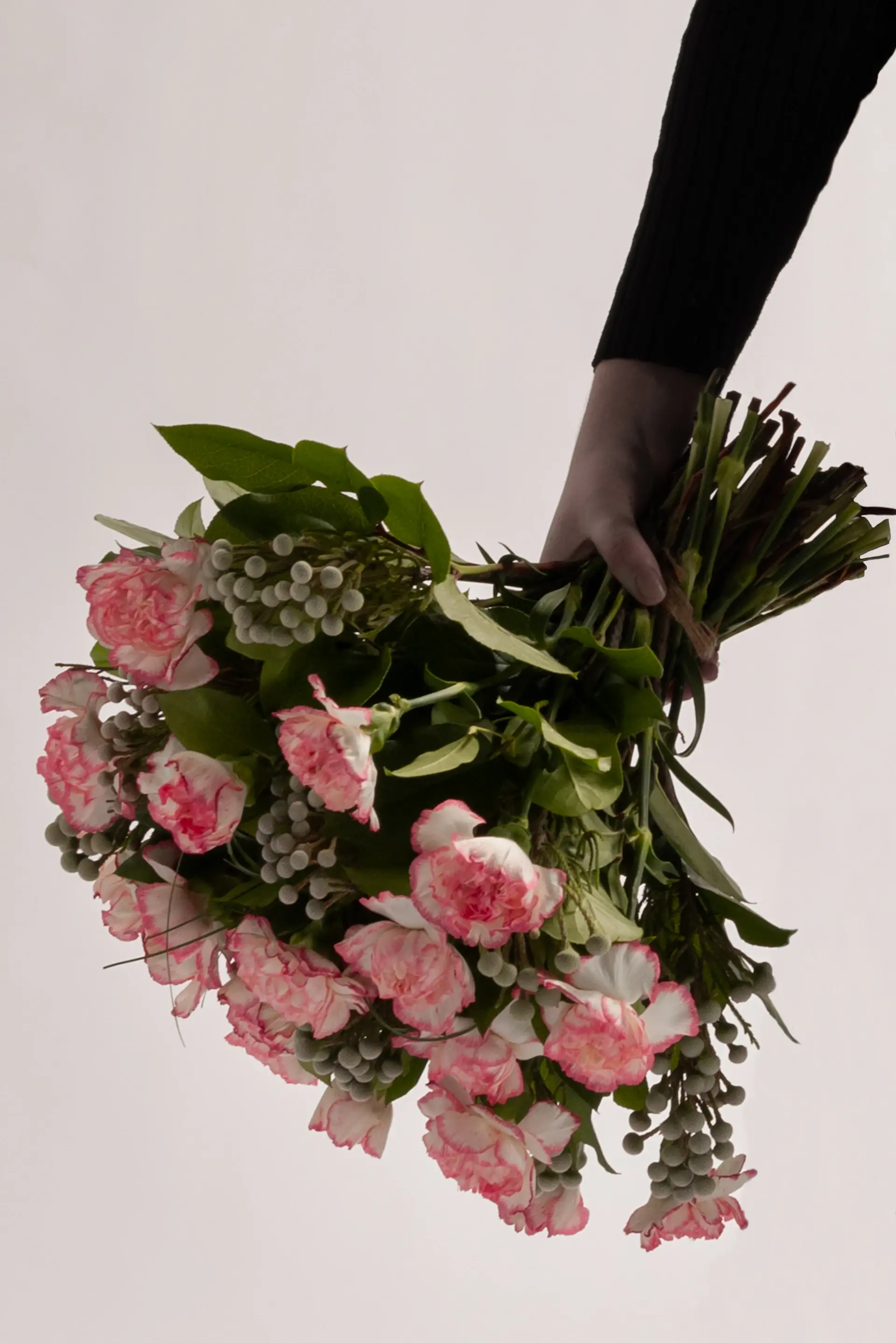 Artisan hands arranging roses with care