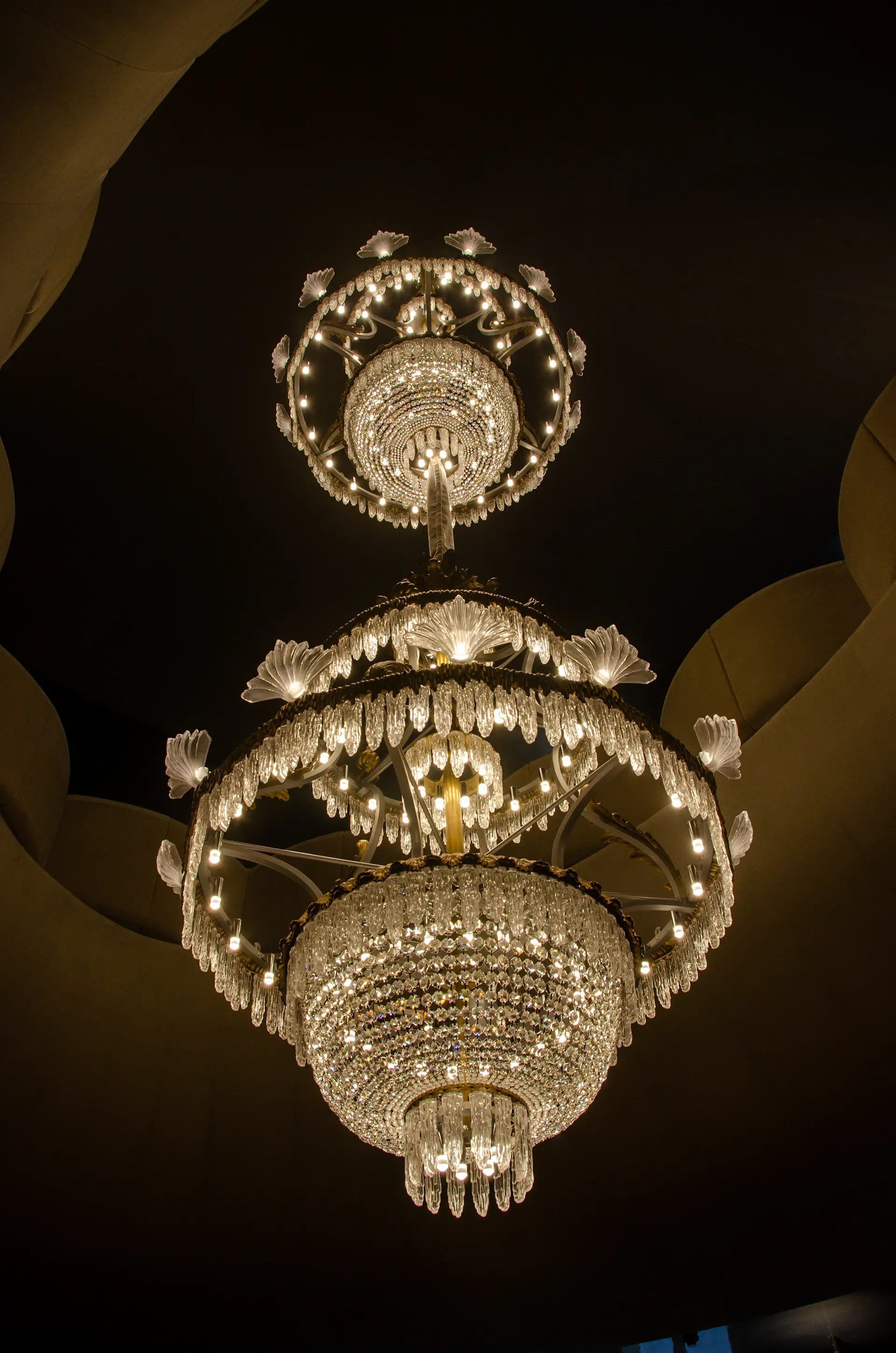 A couple sharing their first dance under a chandelier