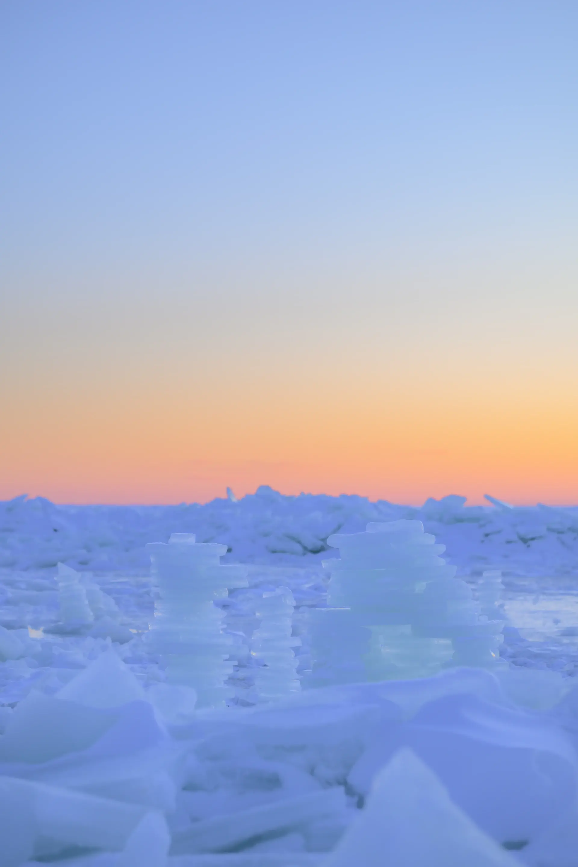 Towering blue tabular icebergs at golden hour