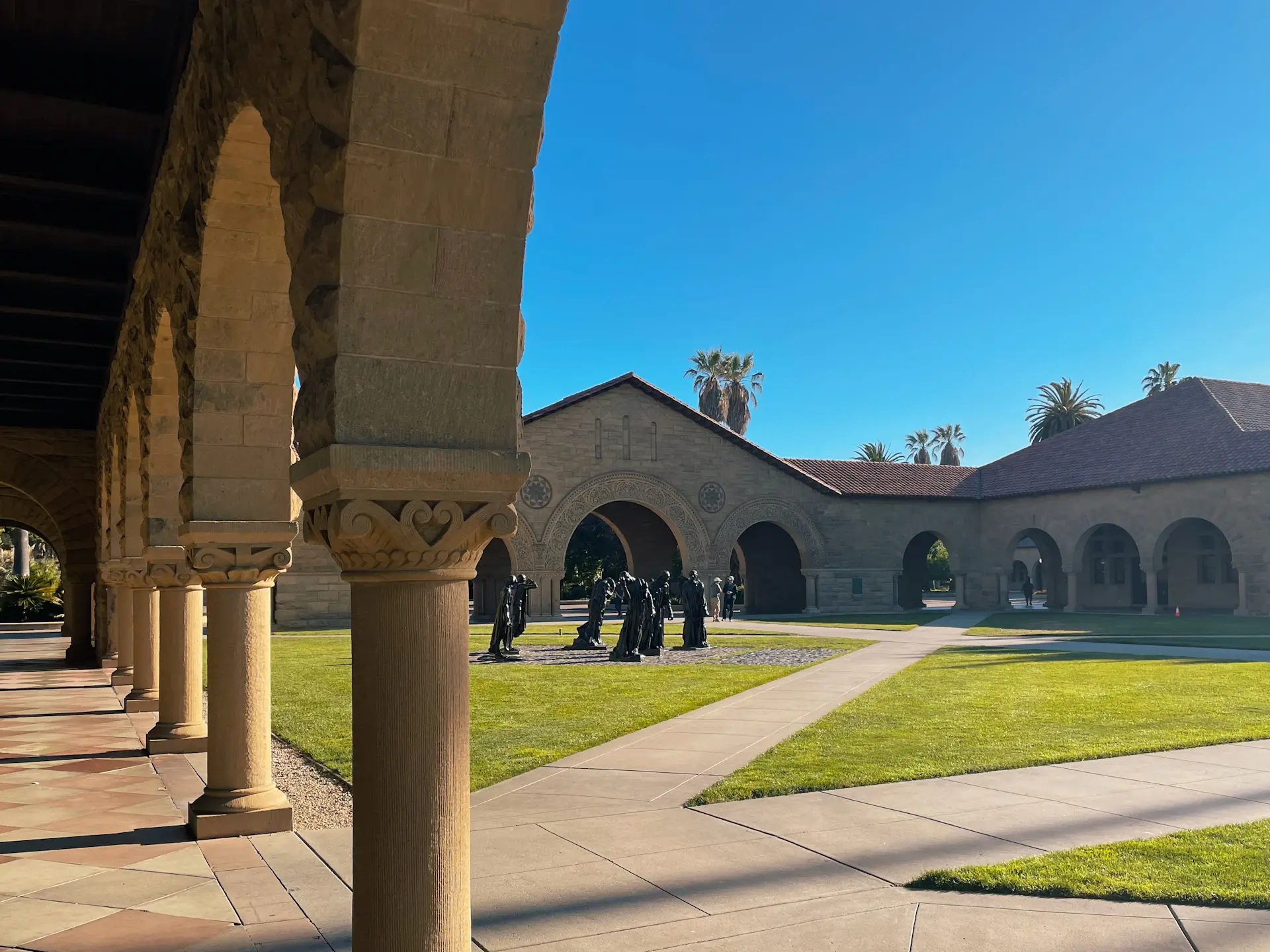 Stanford University campus with sandstone arches and palm trees