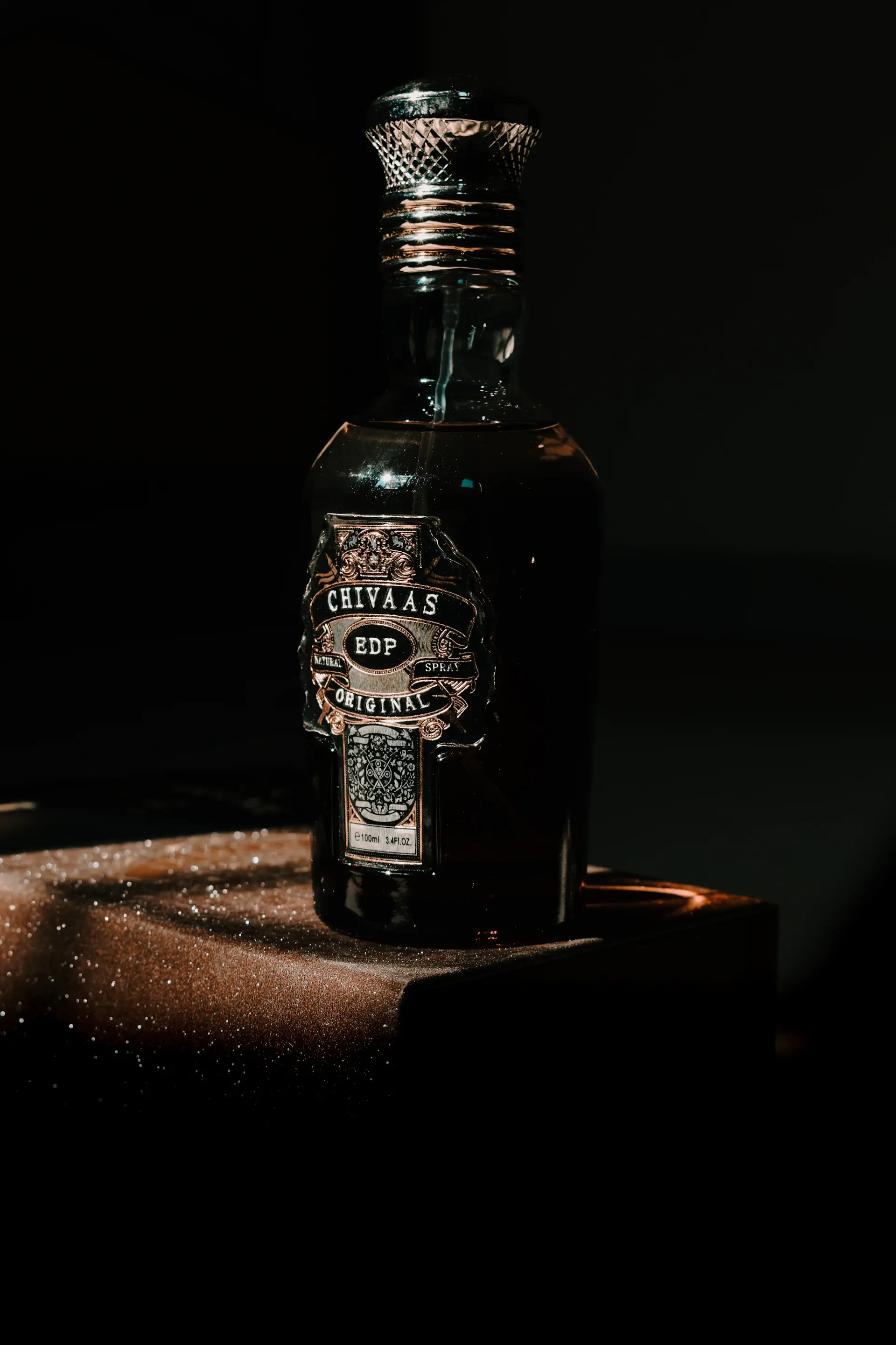 A rare bottle standing on a lit pedestal against a dark ground