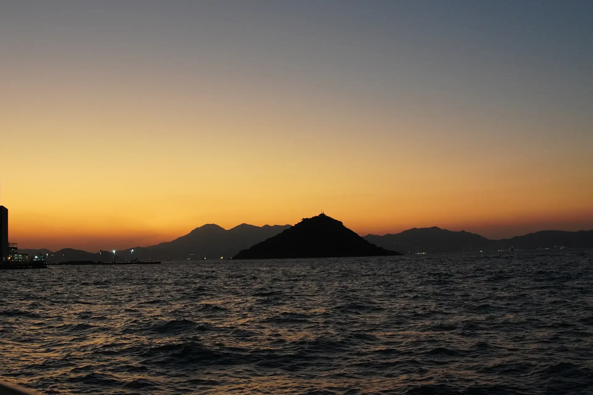 Moody twilight seascape fading toward a distant calm horizon