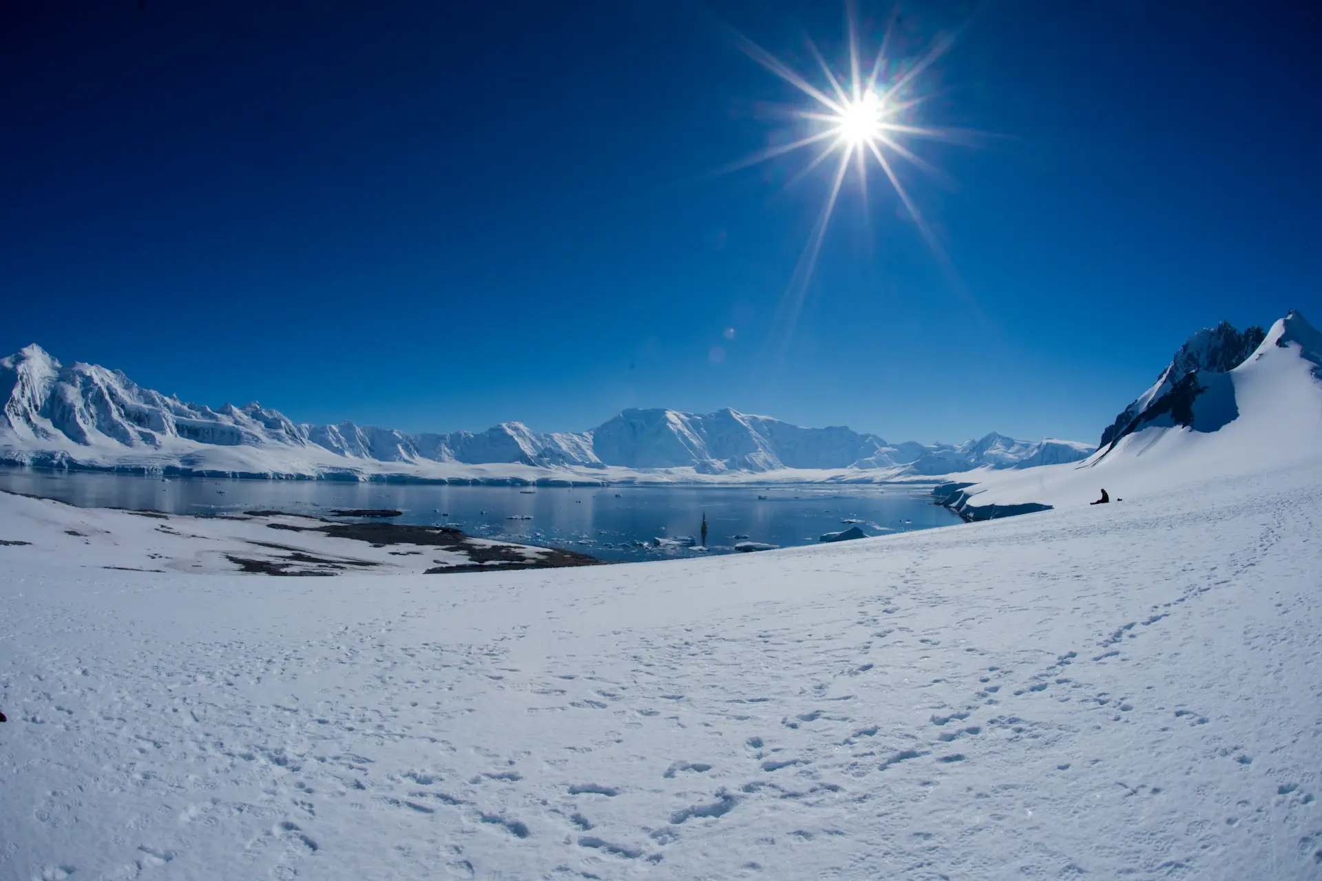 Sunlight breaking across an Antarctic glacier