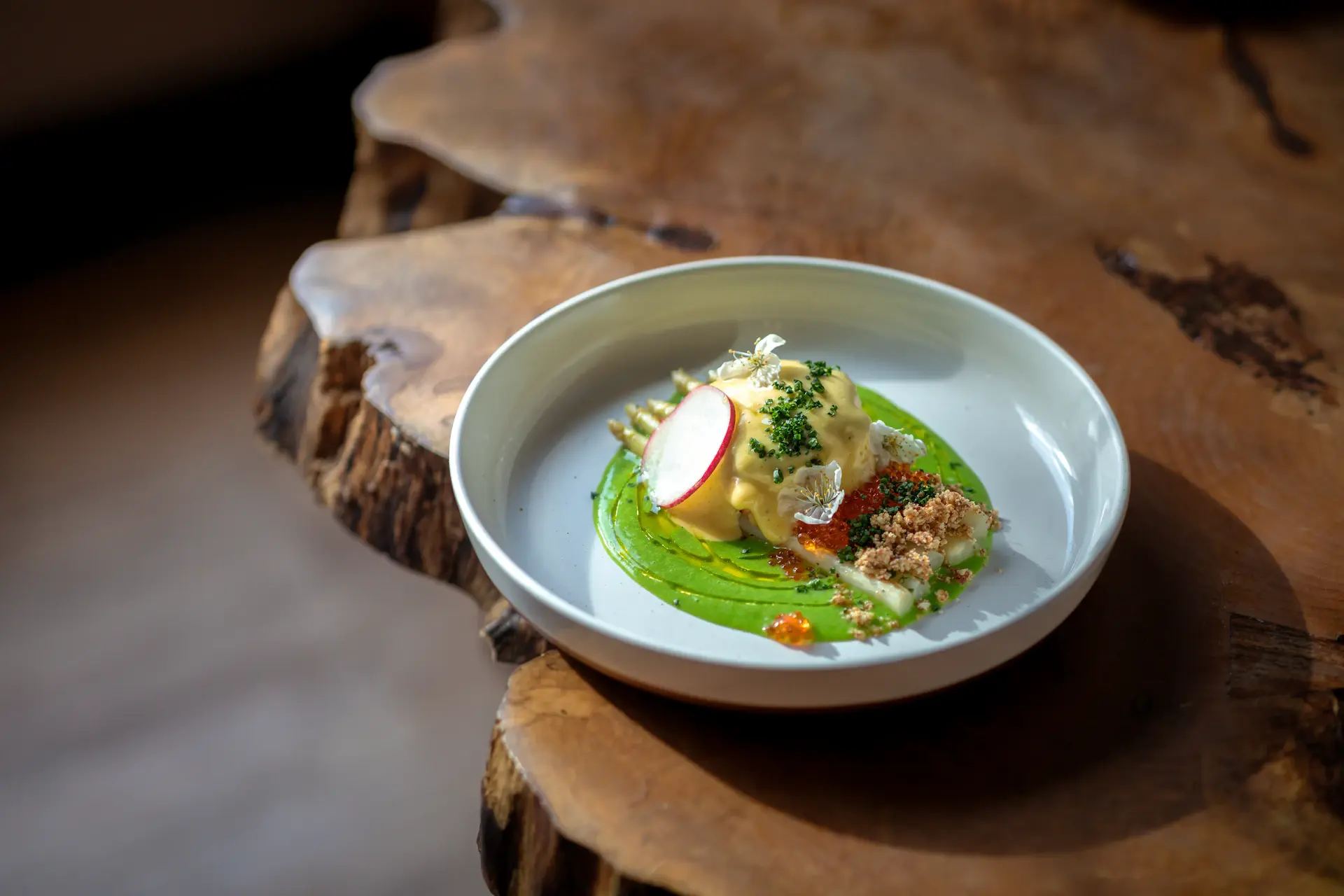 An exquisitely plated signature fine-dining course in warm candlelight