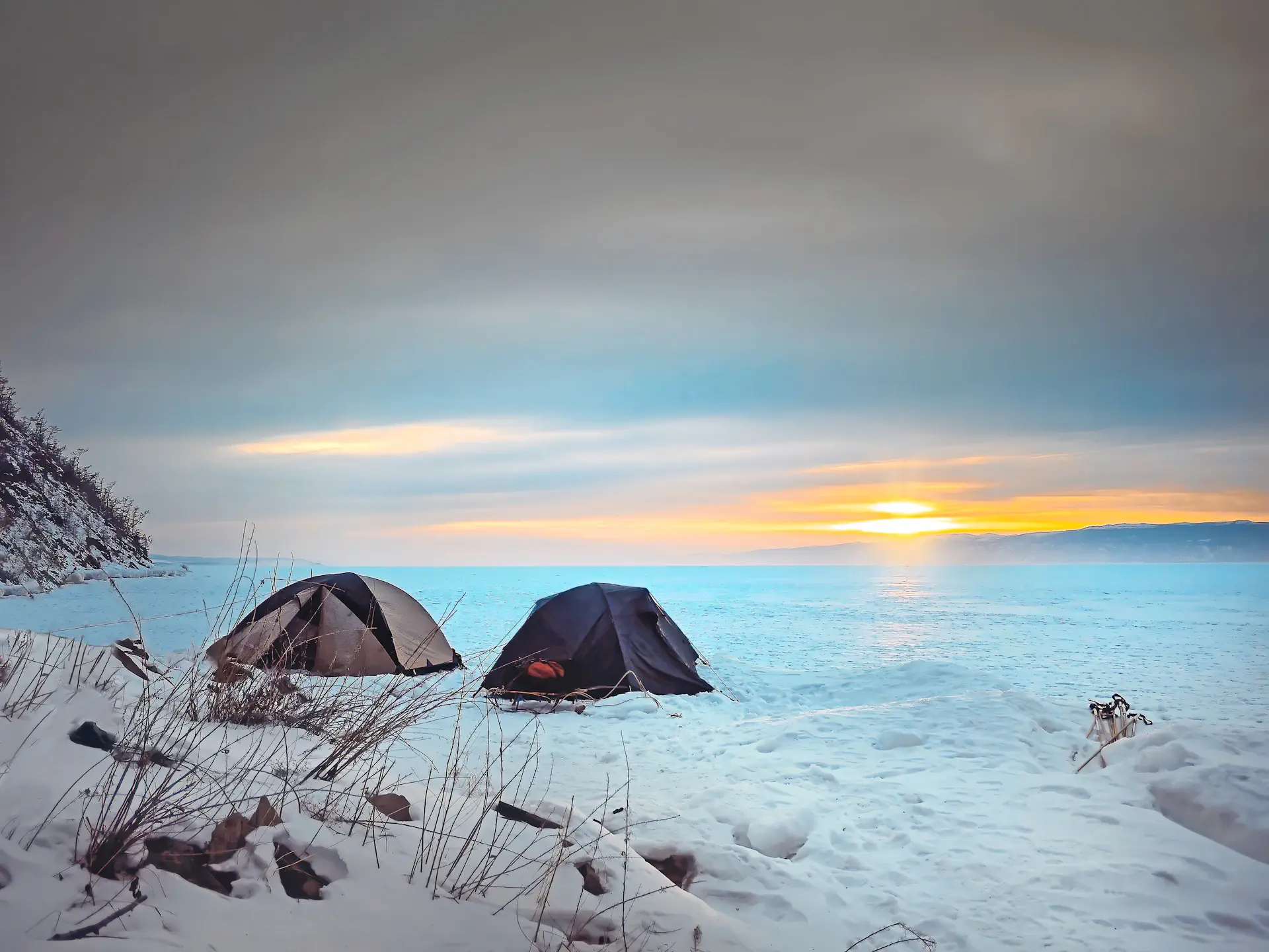 A solitary expedition camp pitched on Antarctic fast ice at twilight
