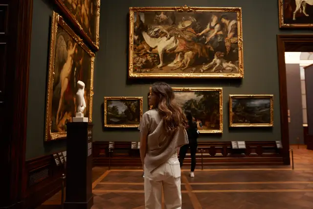 Collector contemplating a hung artwork