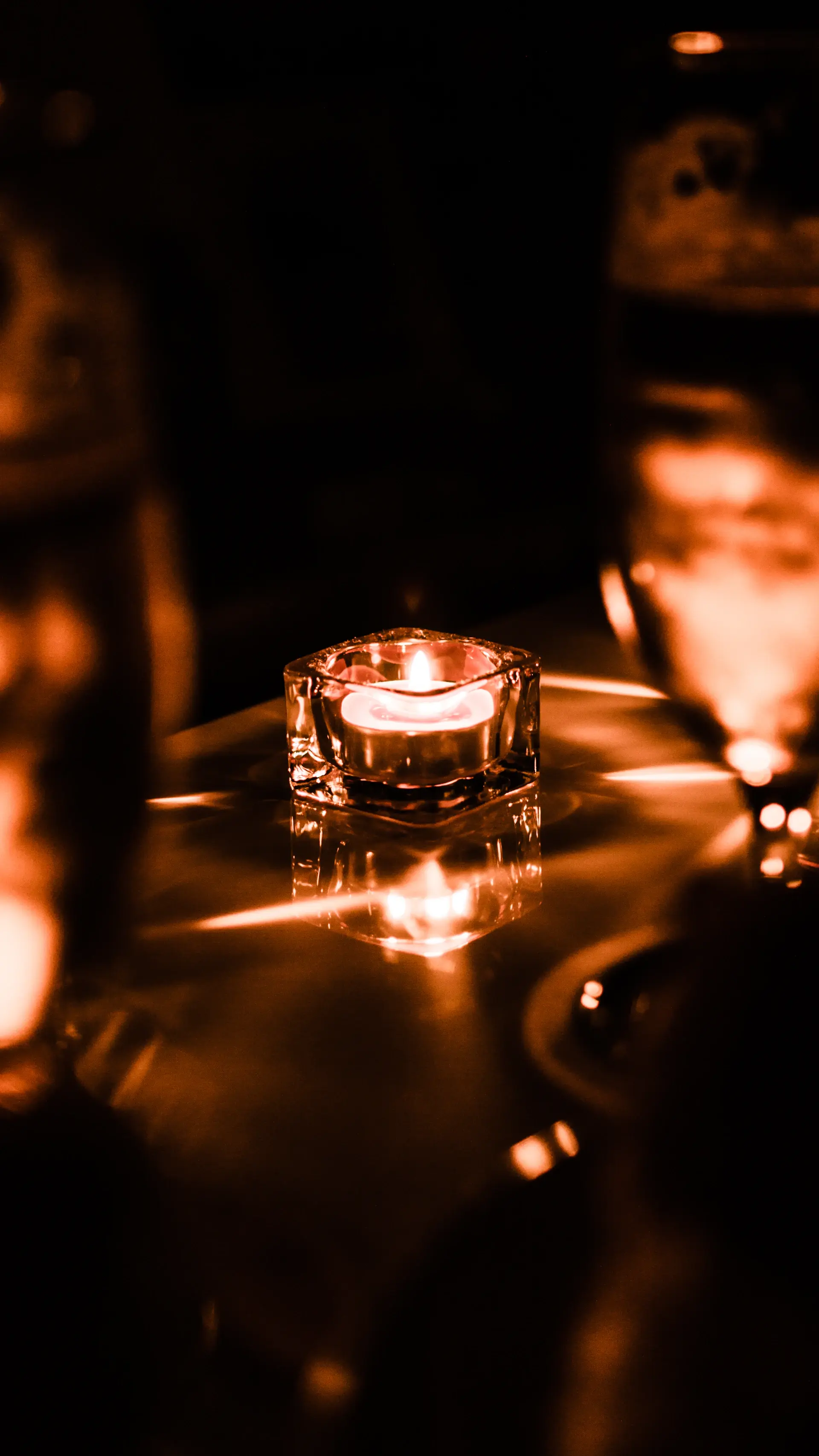 A reception room glowing with warm candlelight
