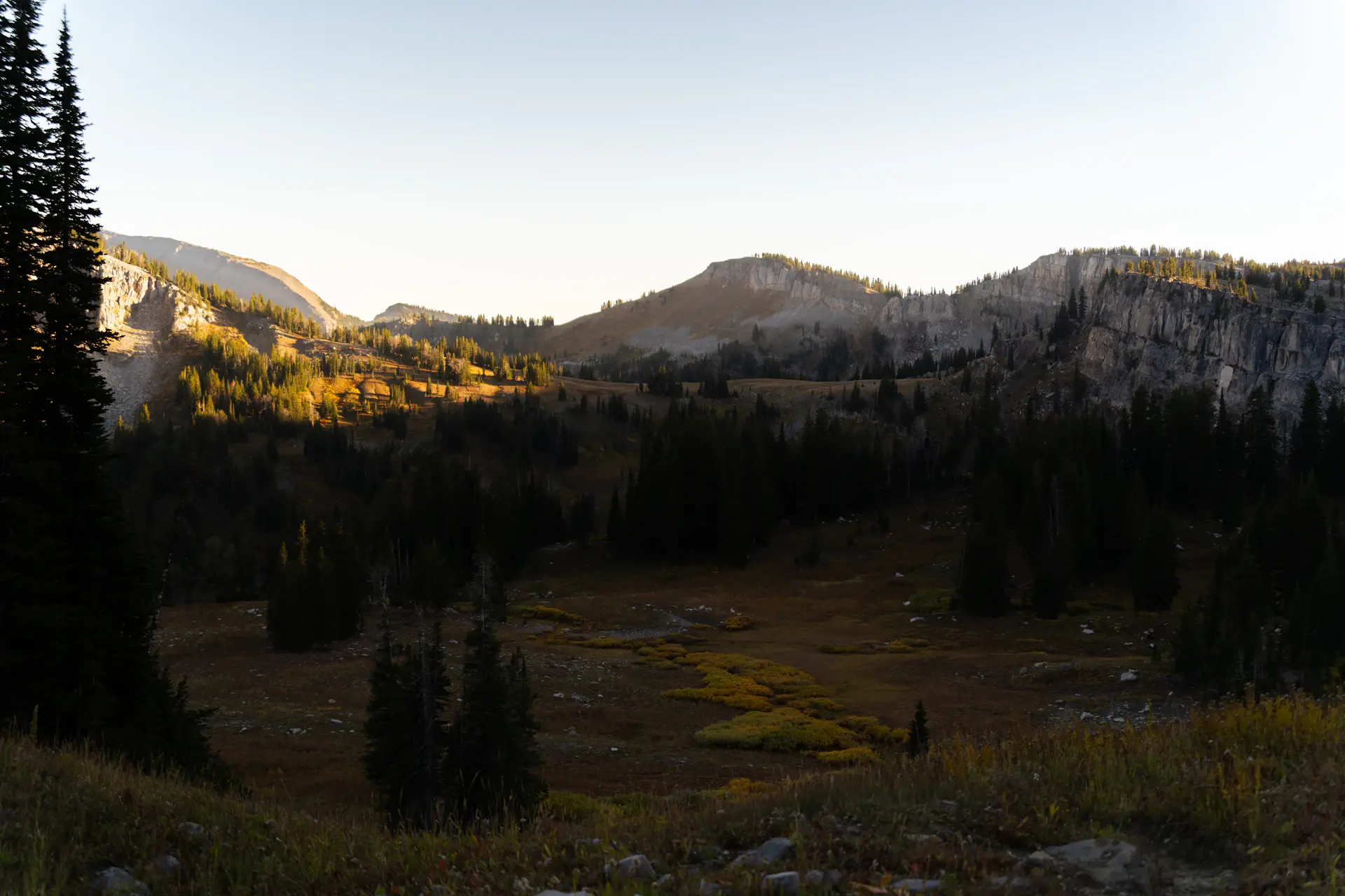 Wide cinematic valley fading into evening haze