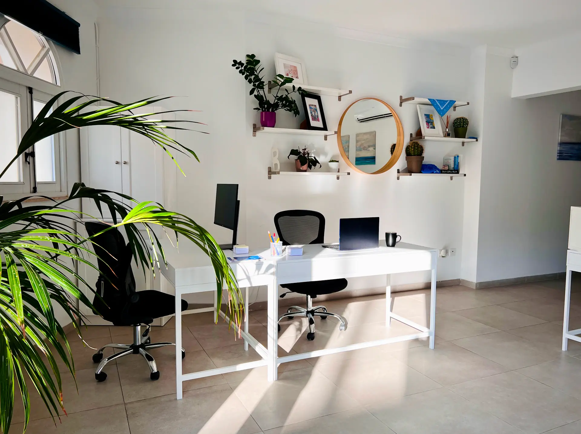 Tidy home office desk with a few calming desk plants