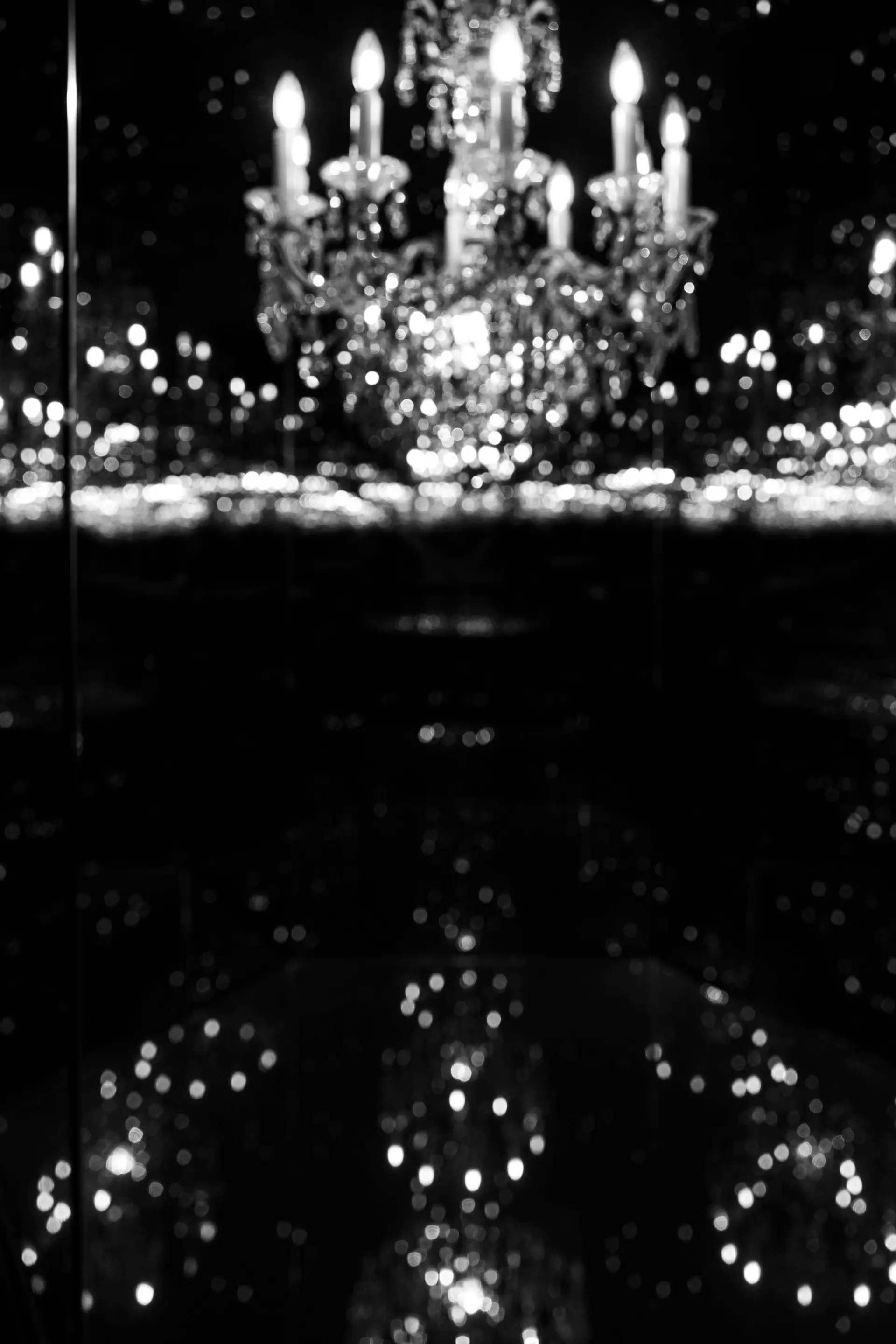 A grand mirrored ballroom set with chandeliers and ivory tables