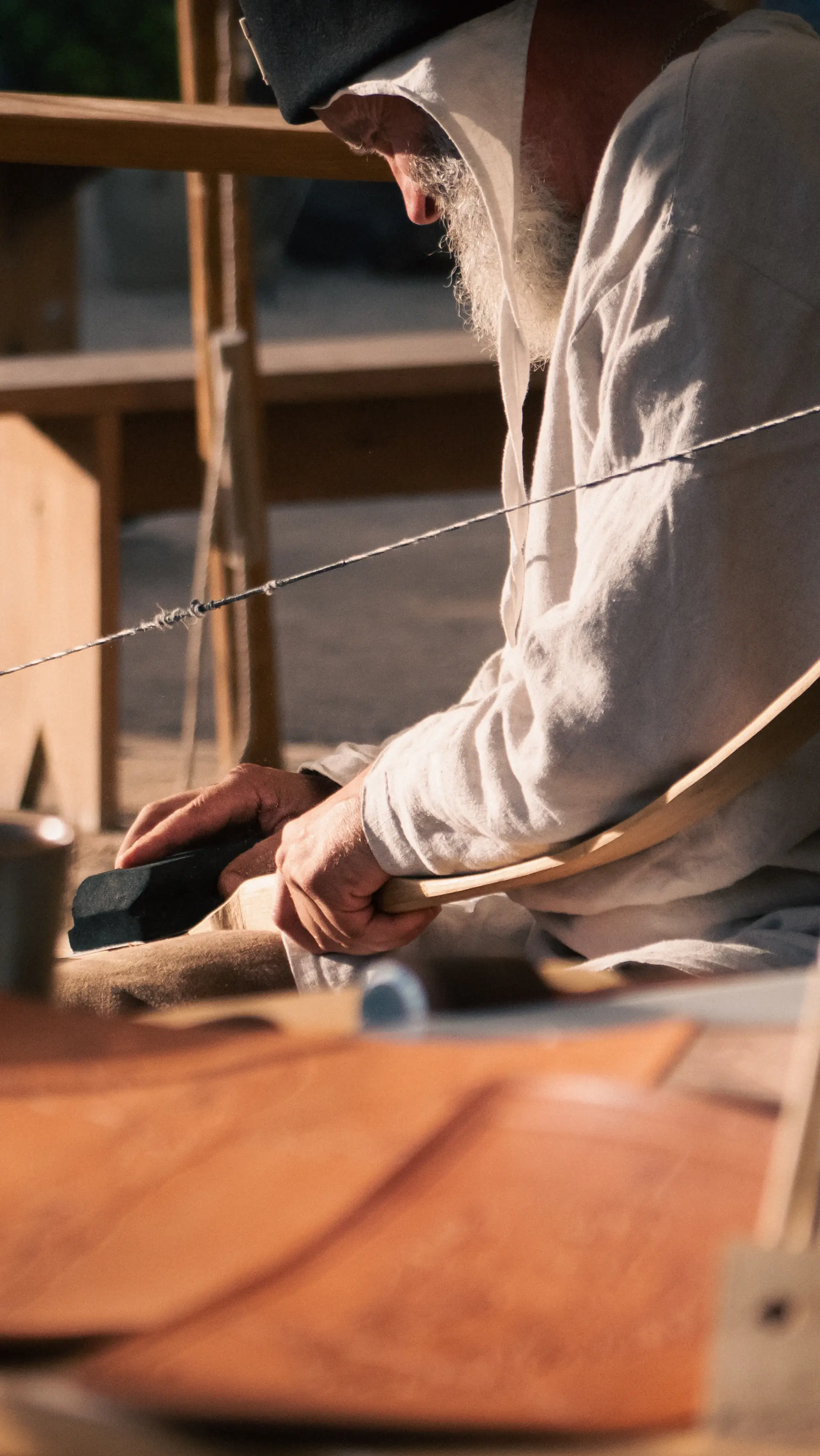 An artisan's hands shaping fine leather over a workbench