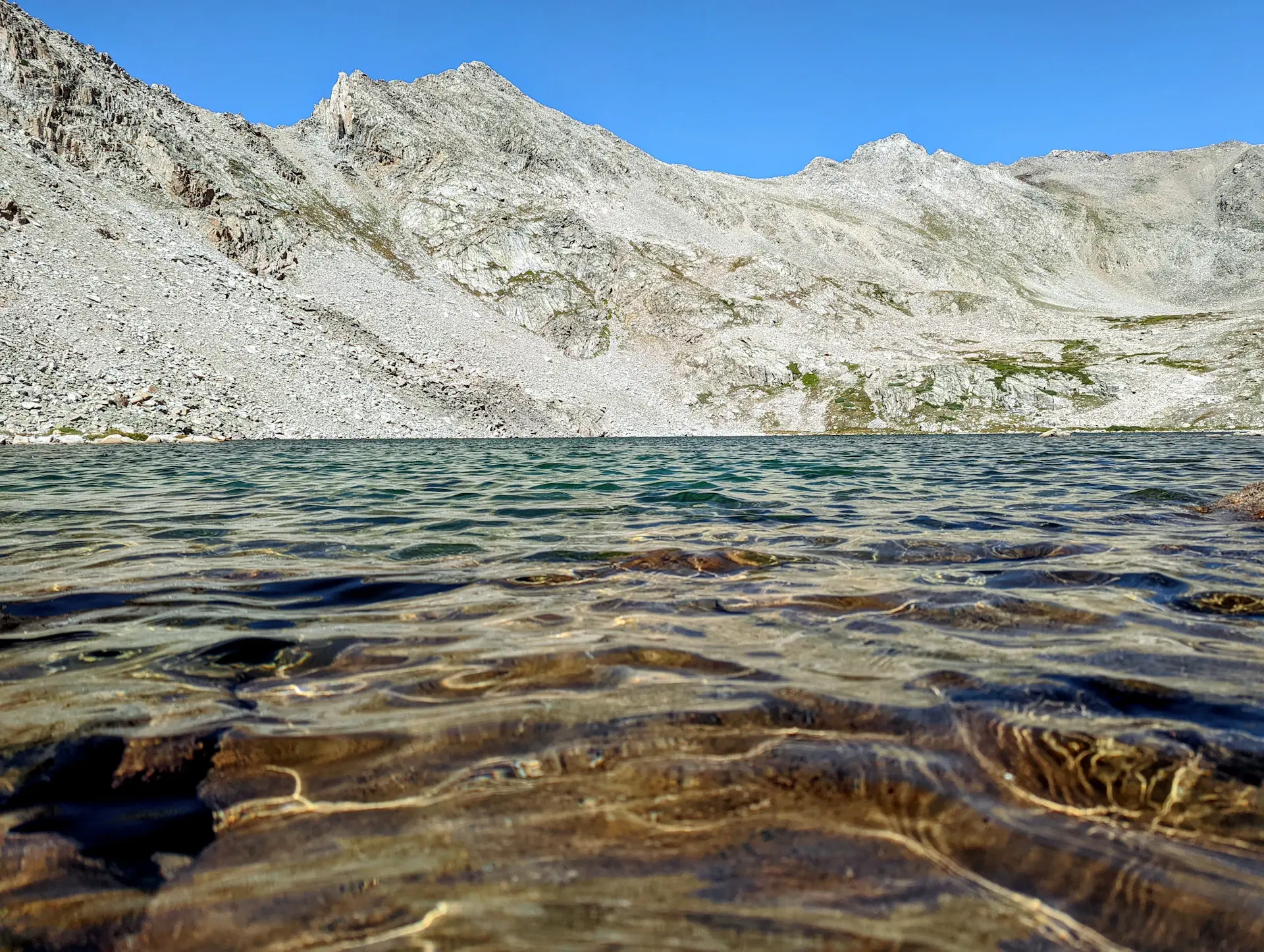 Clear turquoise alpine lake shallows