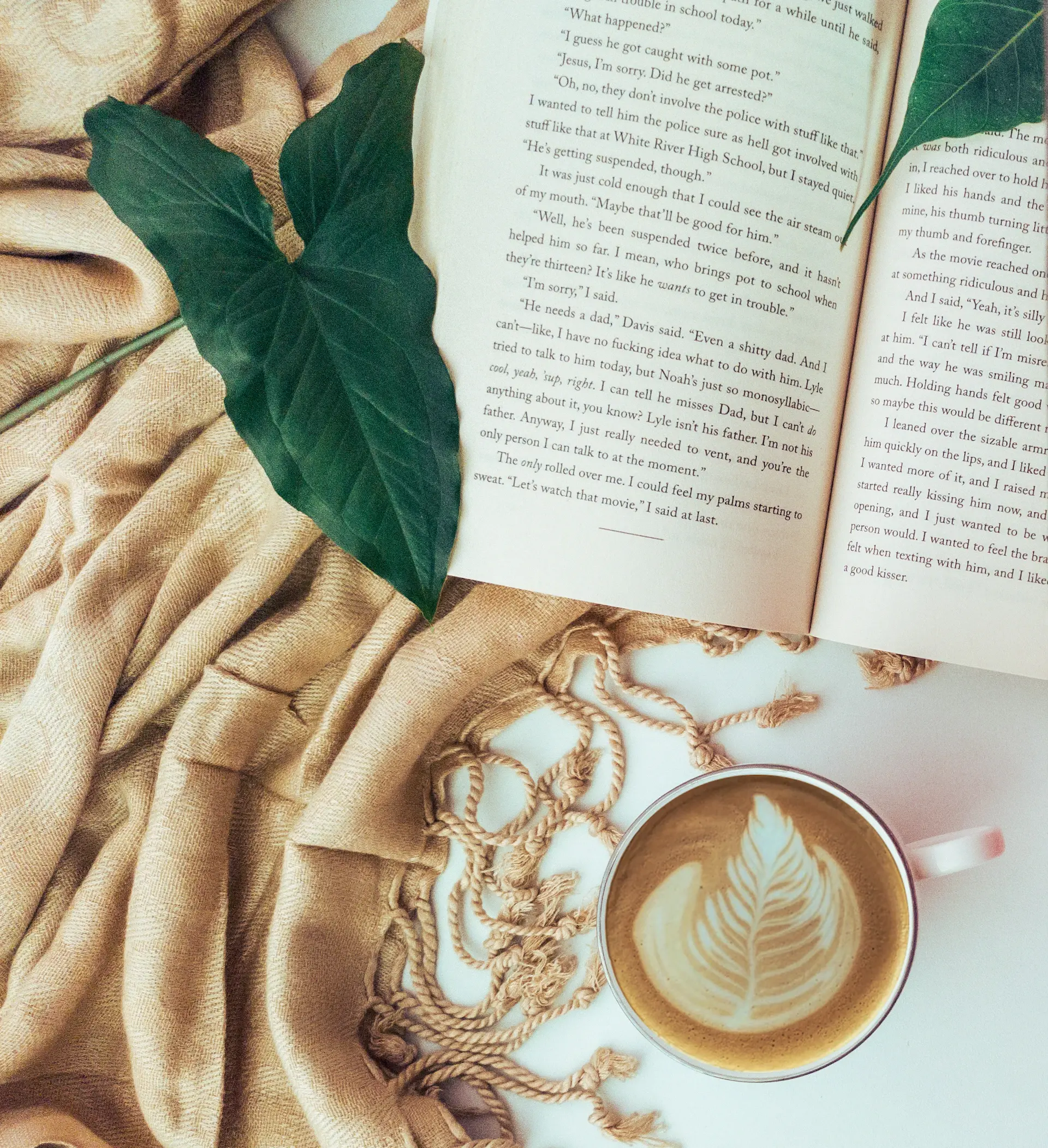 Open book and a half-finished latte